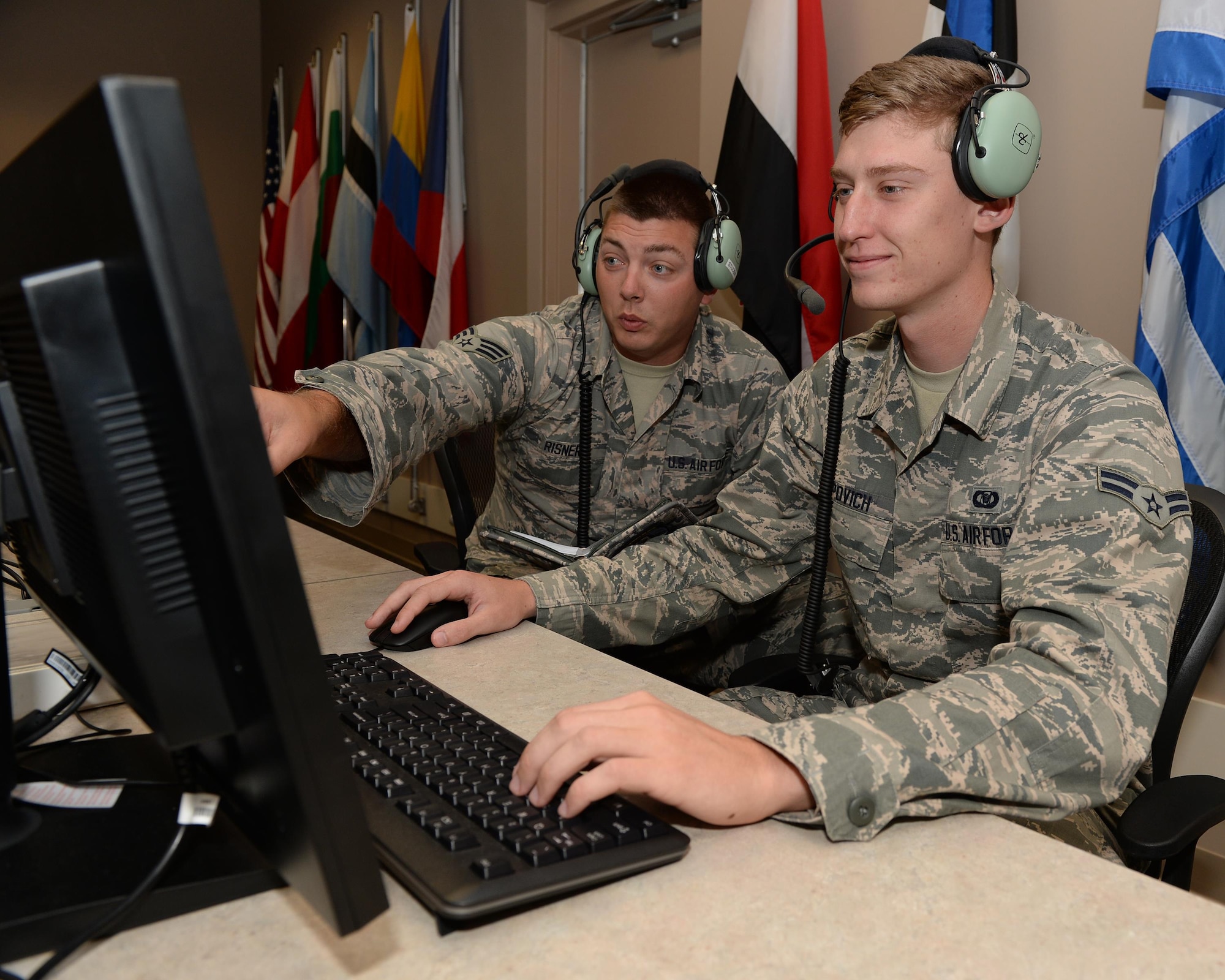 Senior Airman Joseph Risner and Airman 1st Class Blake Tepovich, 337th Air Control Squadron weapons simulation technicians, monitor student’s flight simulation during an Undergraduate Air Battle Manager Course training exercise at Tyndall Air Force Base, Fla. July 13, 2016. Weapons simulations are run to prepare students for dealing with many of the situations an air battle manager may face during air combat. (U.S. Air Force photo by airman 1st Class Cody R. Miller/Released)