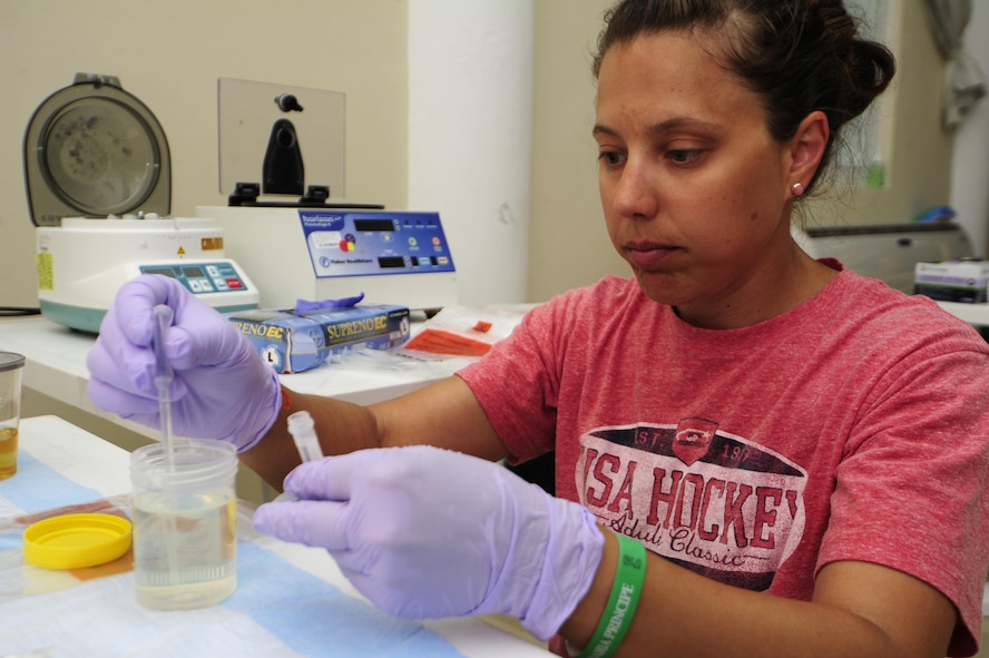 Air Force Staff Sgt. Christina Swope prepares urine samples for testing in Rio San Juan, Dominican Republic