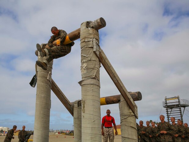 A recruit from Charlie Company, 1st Recruit Training Battalion, climbs over an obstacle during Confidence Course I at Marine Corps Recruit Depot San Diego, July 11. Recruits were instructed to cross over the tallest log by jumping from one log to the other. Annually, more than 17,000 males recruited from the Western Recruiting Region are trained at MCRD San Diego. Charlie Company is scheduled to graduate Sept. 16.