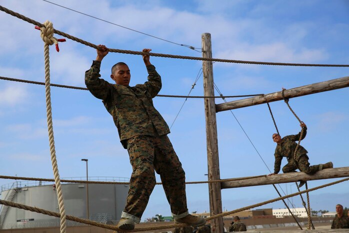 A recruit from Charlie Company, 1st Recruit Training Battalion, maneuvers across an obstacle during Confidence Course I at Marine Corps Recruit Depot San Diego, July 11. The obstacle requires recruits to move quickly across a single cross rope. Annually, more than 17,000 males recruited from the Western Recruiting Region are trained at MCRD San Diego. Charlie Company is scheduled to graduate Sept. 16