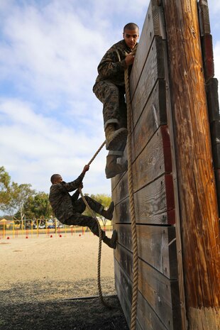 Recruits from Charlie Company, 1st Recruit Training Battalion, climb over a wall during Confidence Course I at Marine Corps Recruit Depot San Diego, July 11. Recruits were instructed to use the rope on both sides of the obstacle to get themselves over the wall. Annually, more than 17,000 males recruited from the Western Recruiting Region are trained at MCRD San Diego. Charlie Company is scheduled to graduate Sept. 16.