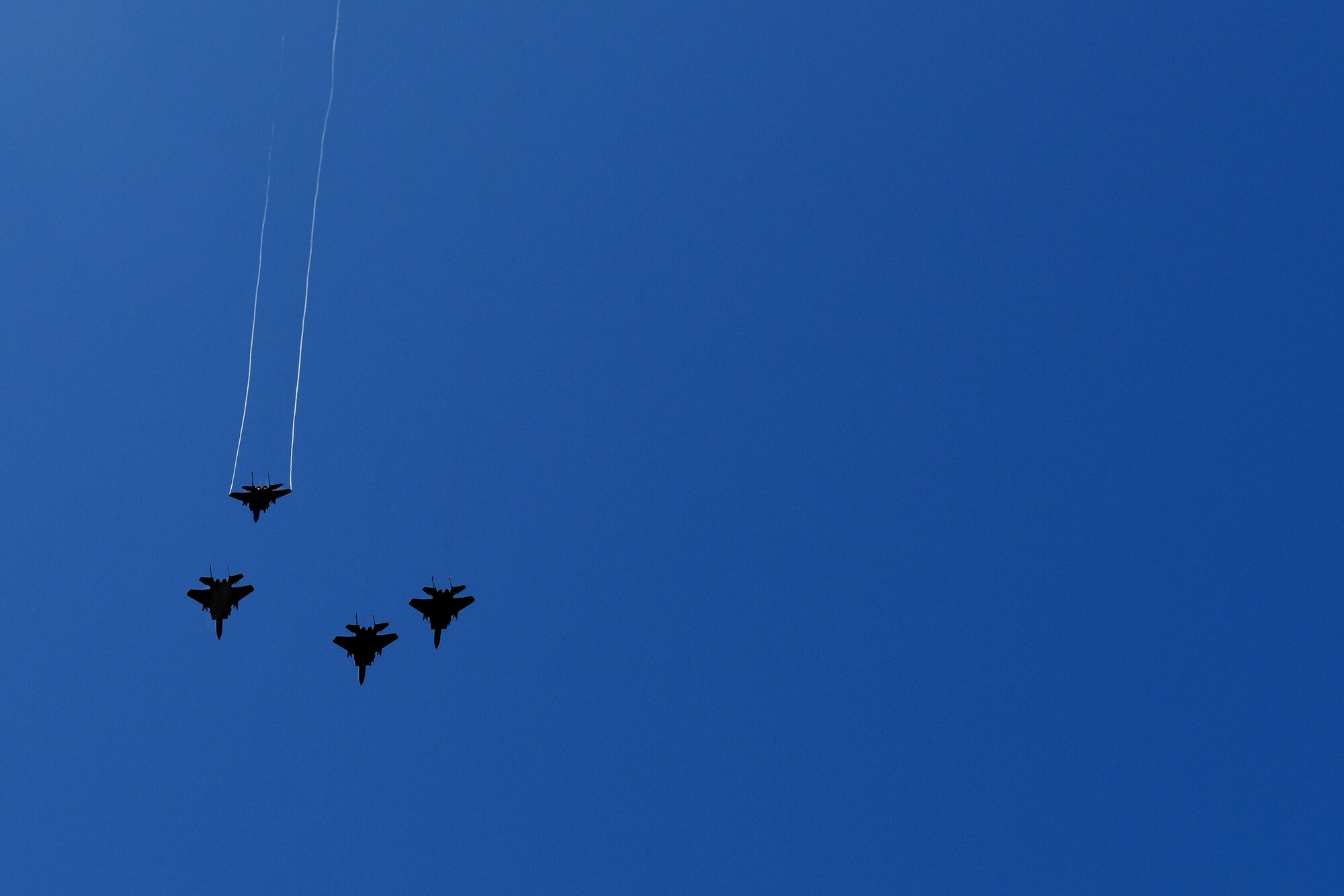 F-15E Strike Eagles perform a missing-man formation flyover during the unveiling of a memorial dedicated to the British Royal Air Force Squadron 71 members, July 8, 2016, at Seymour Johnson Air Force Base, North Carolina. Team Seymour members and invited guests from all over the country attended the ceremony to honor the No. 71 (Eagle) Squadron members. (U.S. Air Force photo by Airman 1st Class Ashley Williamson)