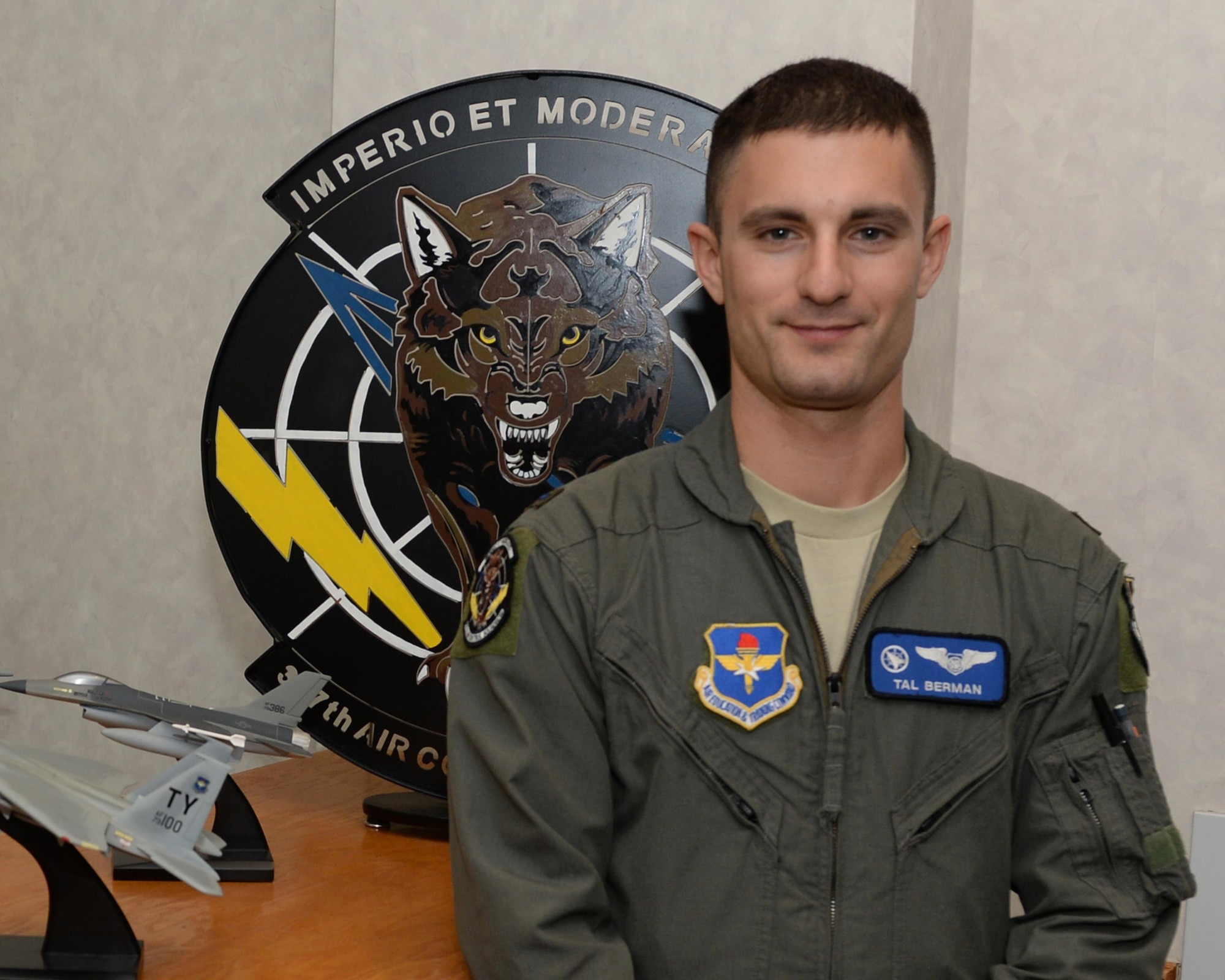 First Lieutenant Tal Berman, 337th Air Control Squadron instructor poses in front of the squadron emblem at Tyndall Air Force Base, Fla. July 13, 2016. Berman joined the Air Force after he discovered his passion for leadership and helping people grow both professionally and personally. (U.S. Air Force photo by Airman 1st Class Cody R. Miller/Released)