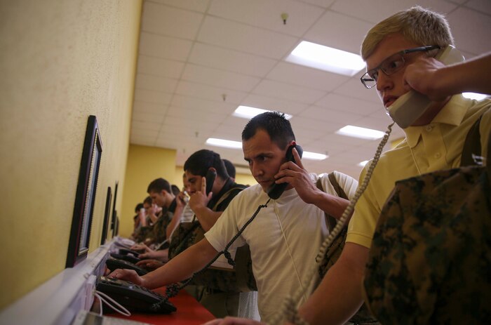 Recruits from Lima Company, 3rd Recruit Training Battalion, make their phone calls home, reading only what is printed on the script in front of them, during receiving at Marine Corps Recruit Depot San Diego, July 11. Recruits will not be able to make another phone call until the end of recruit training. Annually, more than 17,000 males recruited from the Western Recruiting Region are trained at MCRD San Diego. Lima Company is scheduled to graduate Oct. 7.