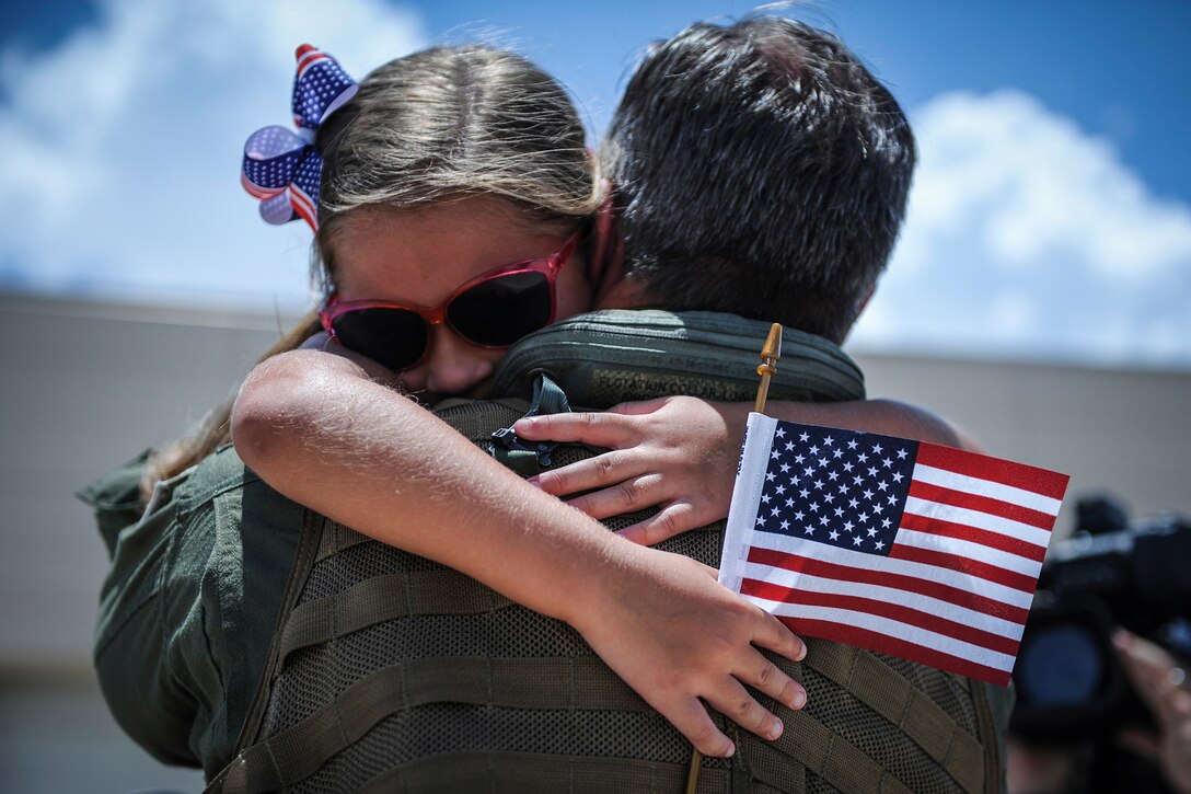 Navy Cmdr. Jason Sherman, commanding officer of the Proud Warriors of Helicopter Maritime Strike Squadron 72, is welcomed home by his daughter at Naval Air Station Jacksonville in Jacksonville, Fla., July 12, 2016.  HSM 72, part of Carrier Air Wing 7, returned home after an eight-month combat deployment in support of Operation Inherent Resolve, maritime security operations, and theater security cooperation efforts in the U.S. 5th and 6th Fleet areas of operations. Navy photo by Petty Officer 2nd Class Timothy Schumaker