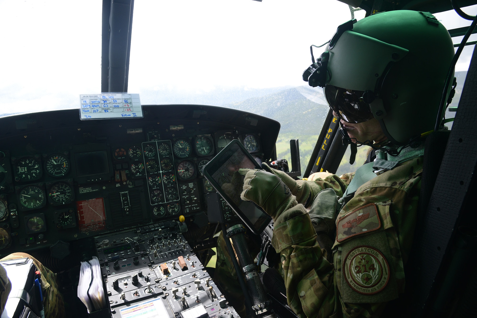 Capt. Greg Johnston, 40th Helicopter Squadron UH-1N Iriquois pilot, checks a topographical map for obstacles in the flight path July 6, 2016, near Malmstrom Air Force Base, Mont. Pilots and flight engineers refer to the map when routing flight paths especially when they encounter obstacles such as weather or restricted air space. (U.S. Air Force photo/Staff Sgt. Delia Marchick)