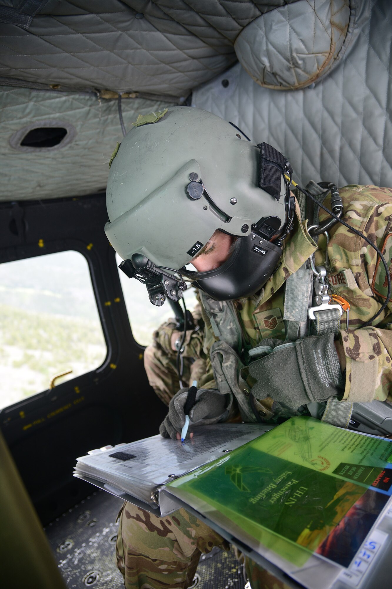 Tech. Sgt. Travis Kidwell, 40th Helicopter Squadron UH-1N Iriquois flight engineer, calculates  take-off and landing data using charts to update a TOLD data card July 6, 2016, near Malmstrom Air Force Base, Mont. Flight engineers update the data when the environment changes because it can affect the performance of the helicopter. (U.S. Air Force photo/Staff Sgt. Delia Marchick)