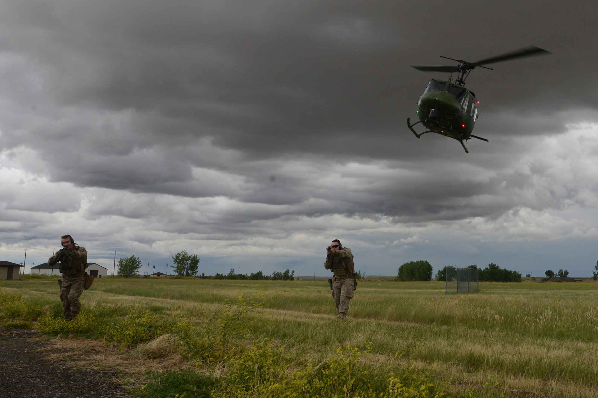 Tactical Response Force Airmen from the 741st Missile Security Forces Squadron practice an infiltration by a UH-1N Iriquois at a mock launch facility July 6, 2016, at Malmstrom Air Force Base, Mont. TRF Airmen are dropped off to provide cover on the ground in the training scenario. (U.S. Air Force photo/Staff Sgt. Delia Marchick)