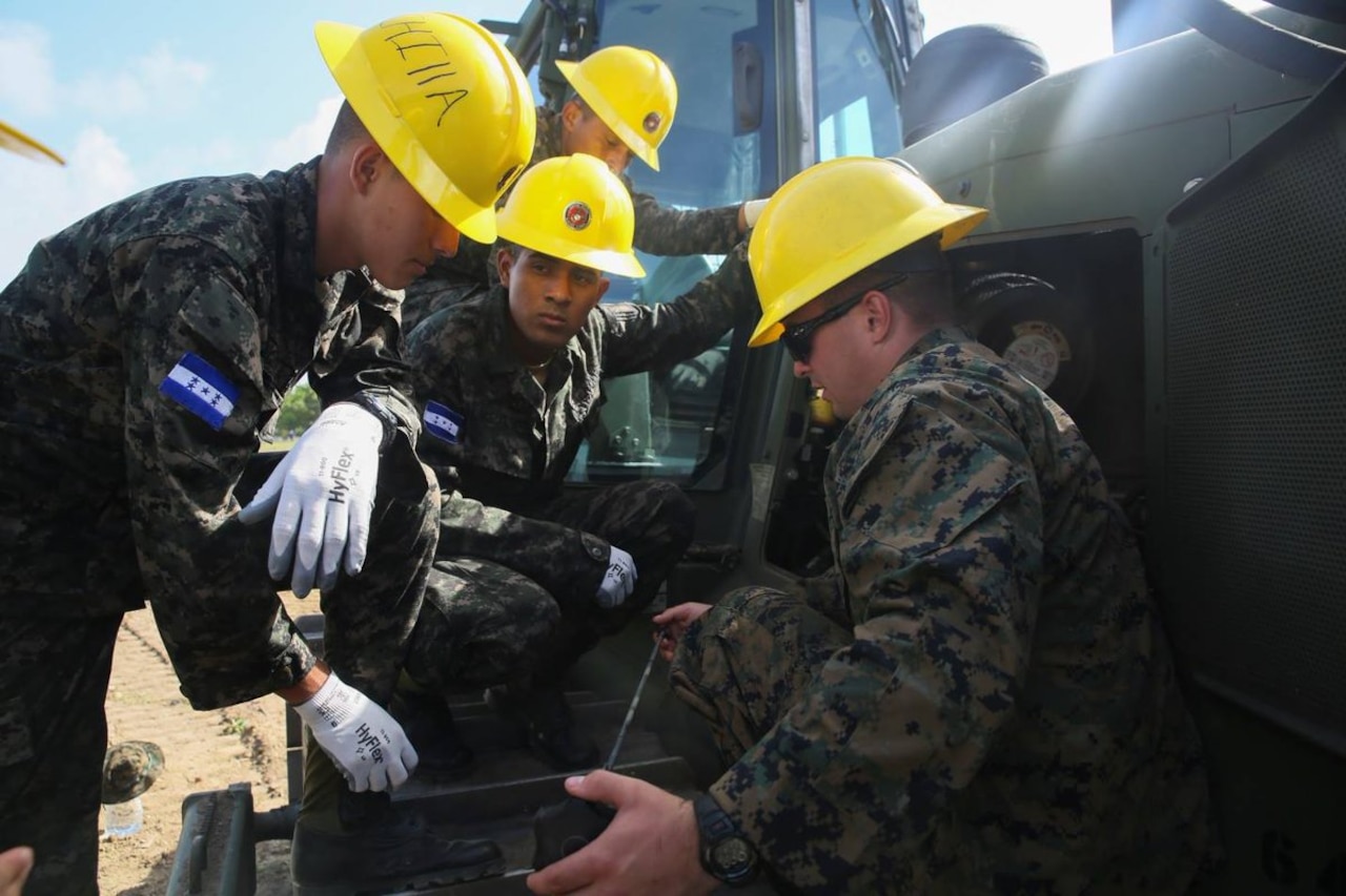 Marine Corps Cpl. Kaleb R. Hougland, senior heavy equipment mechanic with Special Purpose Marine Air-Ground Task Force-Southern Command, inspects a bulldozer during a construction project with Honduran service members and U.S. Marines at Puerto Castilla, Honduras, June 24, 2016. The Marines worked with Honduran engineers on construction and restoration projects and shared knowledge and experience. Marine Corps photo by Cpl. Ian Ferro