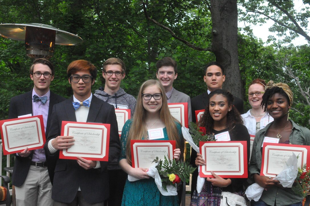 Students from local high schools as well as current college students receive scholarships to continue their education from the Quantico Officers Spouses Organization (QOSO) at a reception aboard MCBQ recently.