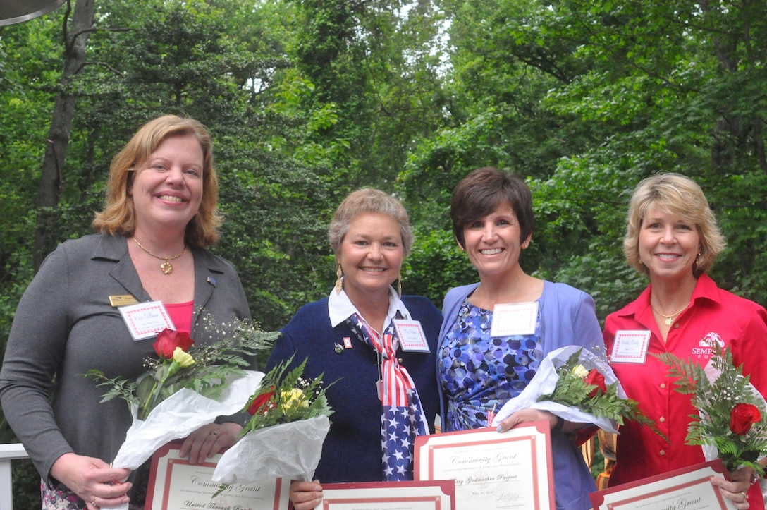 QOSO awarded grants to local chapters of five charities. Accepting the awards are Kara Dallman, United Through Reading; Teri Reece, Blue Star Mothers; Sue Ann Oltman, Fairy Godmother Project; and Wendi Mundy, Semper Fi Fund. Dogs on Deployment also received a grant, but are not pictured.