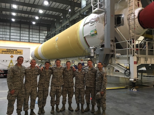 Cadets from the United States Air Force Academy pose for a photo in front of a Delta IV engine at the Horizontal Integration Facility at Cape Canaveral Air Force Station, Fla., June 15, 2016. The cadets visited the 45th Space Wing as a part of the Operation Air Force program, which allows future leaders to experience active duty bases and learn about the various mission capabilities and responsibilities contained within a wing. (Courtesy photo)