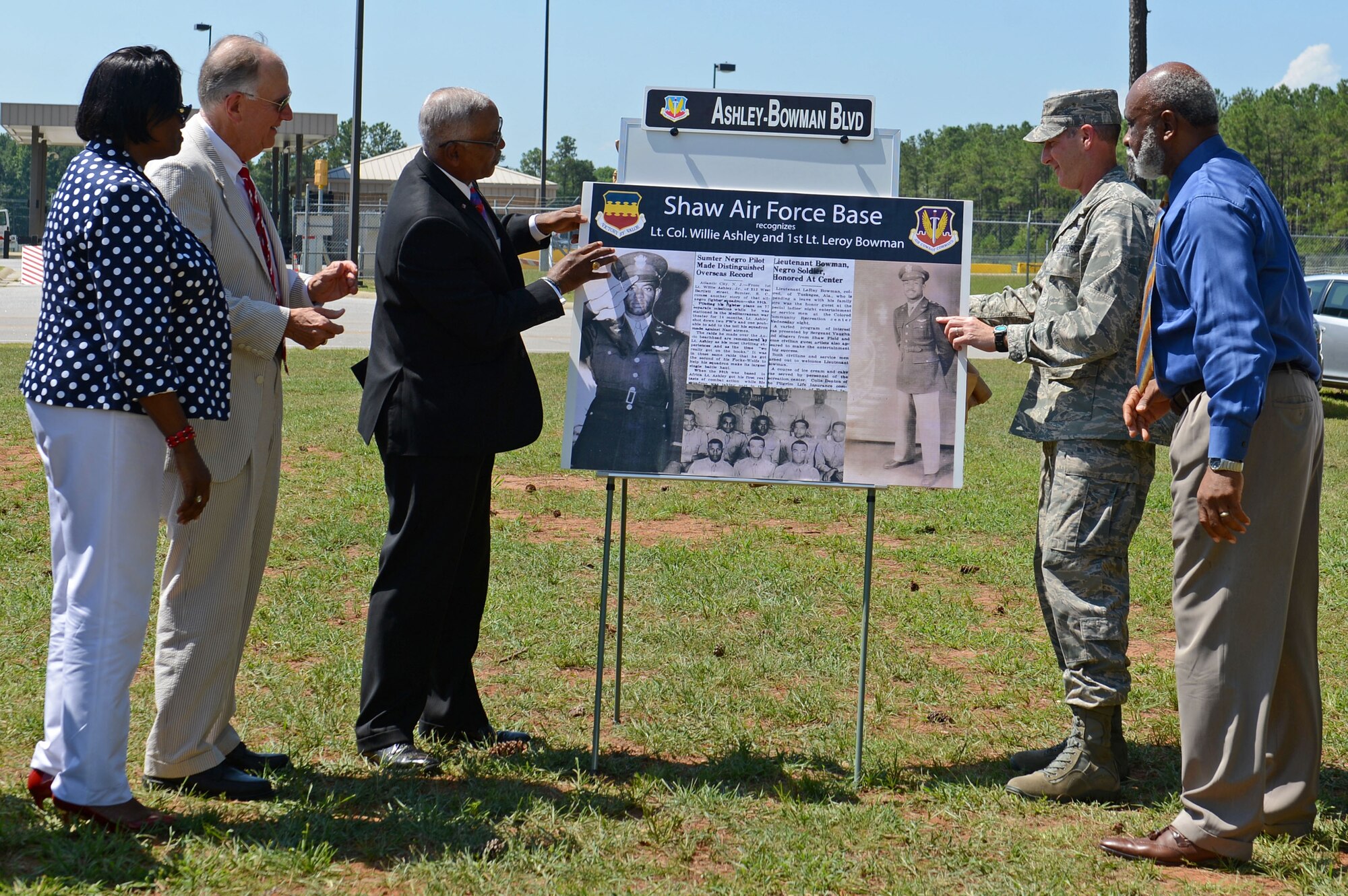 U.S. Air Force Col. Stephen Jost, 20th Fighter Wing commander, and members from the Sumter community unveil the new street name during a street renaming ceremony at Shaw Air Force Base, S.C., July 14, 2016. Throughout the duration of the ceremony, Sumter and Shaw leadership spoke on the history of Lt. Col. Willie Ashley and 1st Lt. Leroy Bowman, and their impact on the future of the Air Force. (U.S. Air Force photo by Airman 1st Class Christopher Maldonado)