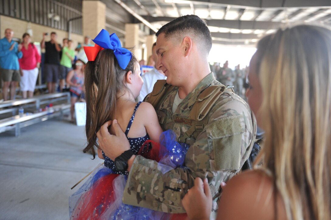 Staff Sgt. Sean Carnahan, a fuels systems craftsman with the 1st Special Operations Squadron, embraces his daughter at Hurlburt Field, Fla., July 7, 2016. Operation Homecoming welcomed Airmen returning home from overseas deployment. (U.S. Air Force photo by Airman Dennis Spain)

