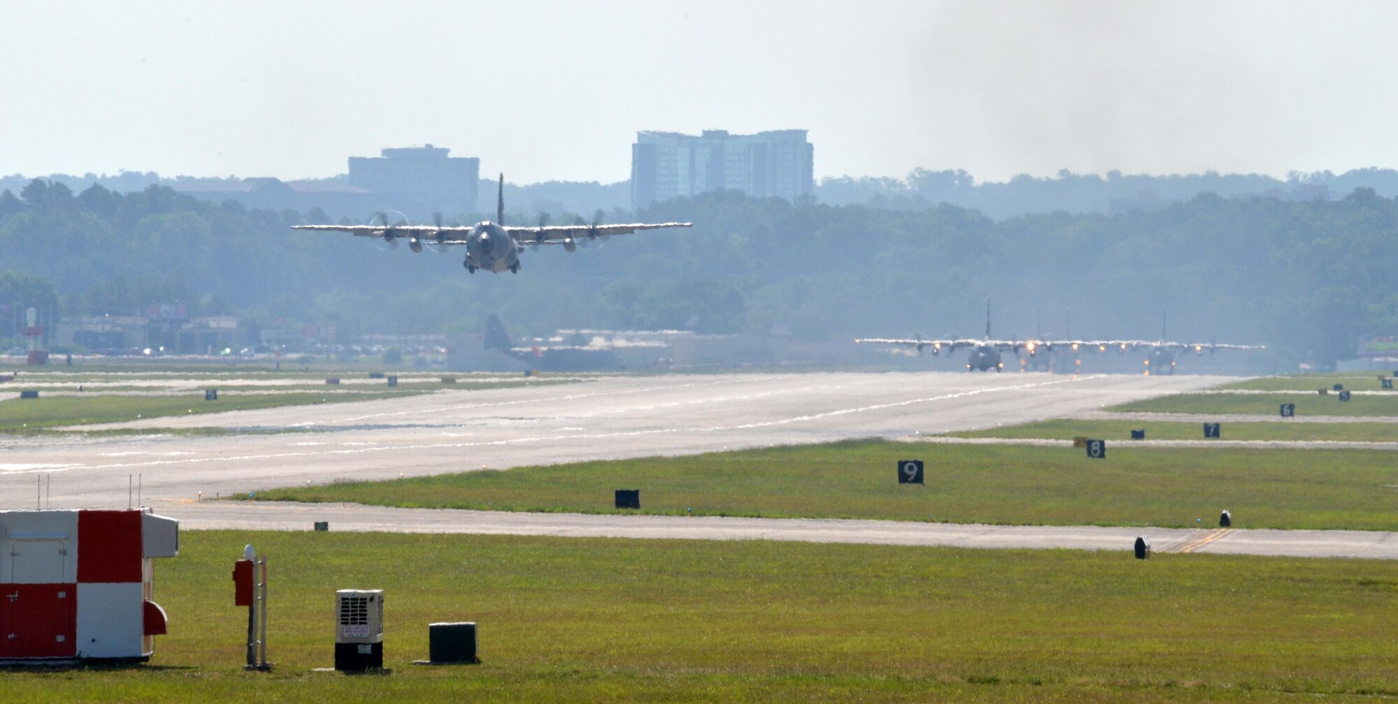 A formation of C-130 Hercules from the 700th Airlift Squadron take off from the flightline of Dobbins Air Reserve Base, Ga., on July 9, 2016. The 94th Airlift Wing formation conducted proficiency training missions over downtown Atlanta and much of the metro area. (U.S. Air Force photo/Tech. Sgt. Kelly Goonan)