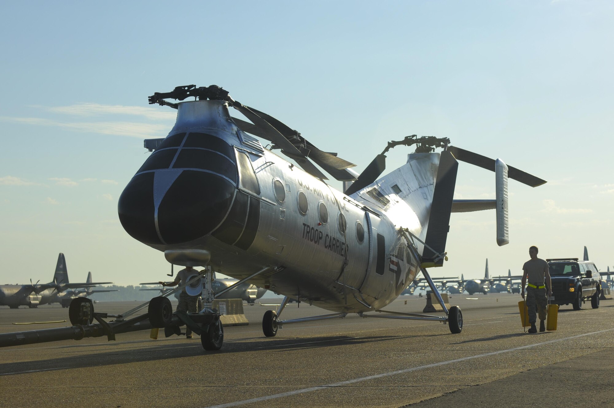 U.S. Air Force Airmen from the 314th Maintenance Group walk alongside an H-21B helicopter while towing the aircraft to Heritage Park June 25, 2016, at Little Rock Air Force Base, Ark. The helicopter was restored by volunteers from the 314th MXG and will be the tenth static display aircraft to be placed in Heritage Park. (U.S. Air Force photo/Senior Airman Harry Brexel) 