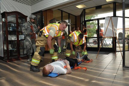 902nd Civil Engineer fire department personnel provide treatment to a simulated victim during an active shooter exercise at Joint Base San Antonio-Randolph July 12. The active shooter exercise tested the threat response time and effectiveness of Joint Base San Antonio’s emergency responders and support agencies. The exercise replicated possible real-world events and was designed to enhance training and readiness of JBSA emergency responders during threats to the installation and units.