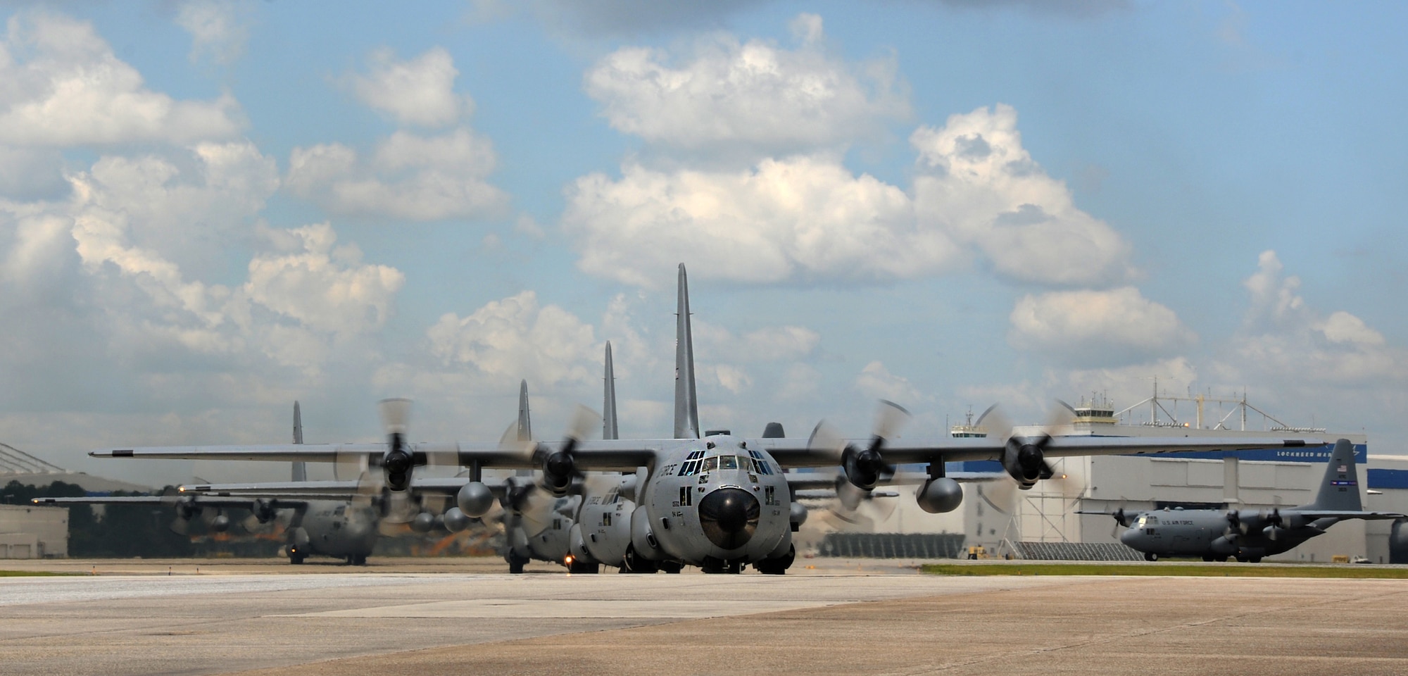 C-130s from the 94th Airlift Wing travel down the ramp at Dobbins Air Reserve Base, Ga. after a formation flight on July 9, 2016. The formation's flight path traversed over the metro Atlanta area and gave the wing's Airmen a chance to showcase their skills in view of the local community. (U.S. Air Force photo by Staff Sgt. Alan Abernethy)