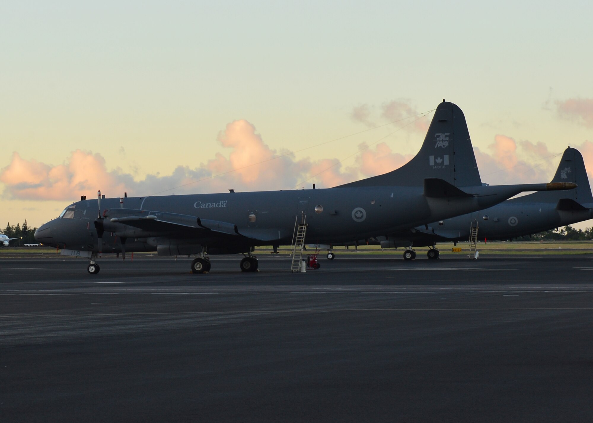 Two CP-140 Aurira aircraft, from the Royal Canadian Air Force, site on the flightline of Joint Base Pearl Harbor-Hickam during the Rim of the Pacific Exercises 11 June, 2016. Twenty-six nations, 49 ships, six submarines, about 200 aircraft, and 25,000 personnel are participating in Rim of the Pacific 2016 from June 29 to Aug. 4 in and around the Hawaiian Islands and Southern California. The world’s largest international maritime exercise, RIMPAC provides a unique training opportunity while fostering and sustaining cooperative relationships between participants critical to ensuring the safety of sea lanes and security on the world’s oceans. RIMPAC 16 is the 25th exercise in the series that began in 1971. (U.S. Air Force photo by Tech. Sgt. Aaron Oelrich) 