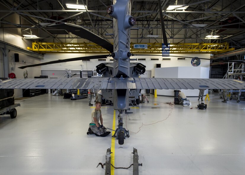 An HH-60G Pave Hawk helicopter sits on jack stands, July 7, 2016 at Moody Air Force Base, Ga. U.S. Air Force Airmen assigned to the 41st Helicopter Maintenance Unit check the weight of the aircraft while quality assurance inspectors make sure they follow the correct procedures and annotate it in the technical data logs. (U.S. Air Force photo by Airman 1st Class Janiqua P. Robinson)