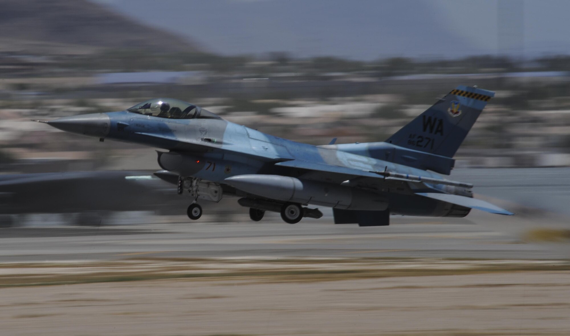 An F-16 Fighting Falcon, assigned to the 64th Aggressor Squadron, takes off during the first day of Red Flag 16-3 at Nellis Air Force Base, Nev., July 11, 2016. Red Flag involves a variety of attack, fighter, bomber, reconnaissance, electronic warfare, air lift support, search and rescue aircraft. (U.S. Air Force photo by Airman 1st Class Kevin Tanenbaum)