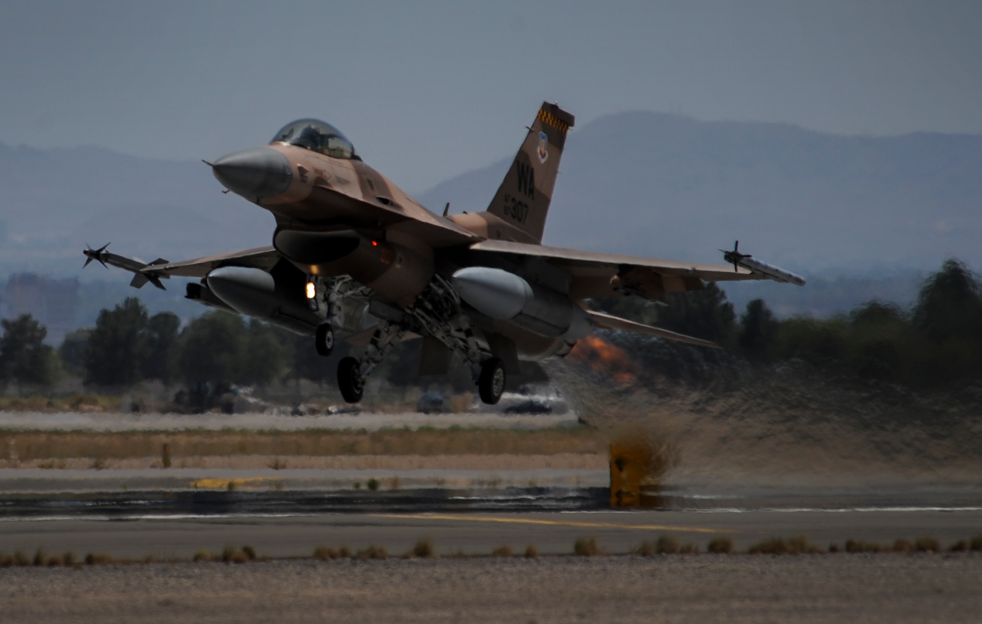 An F-16 Fighting Falcon, assigned to the 64th Aggressor Squadron, takes off during the first day of Red Flag 16-3 at Nellis Air Force Base, Nev., July 11, 2016. The 64th AGRS plays a critical role as the opposing force during Red Flag by providing combat air forces from around the world challenges to prepare for future conflicts of war. (U.S. Air Force photo by Airman 1st Class Kevin Tanenbaum)