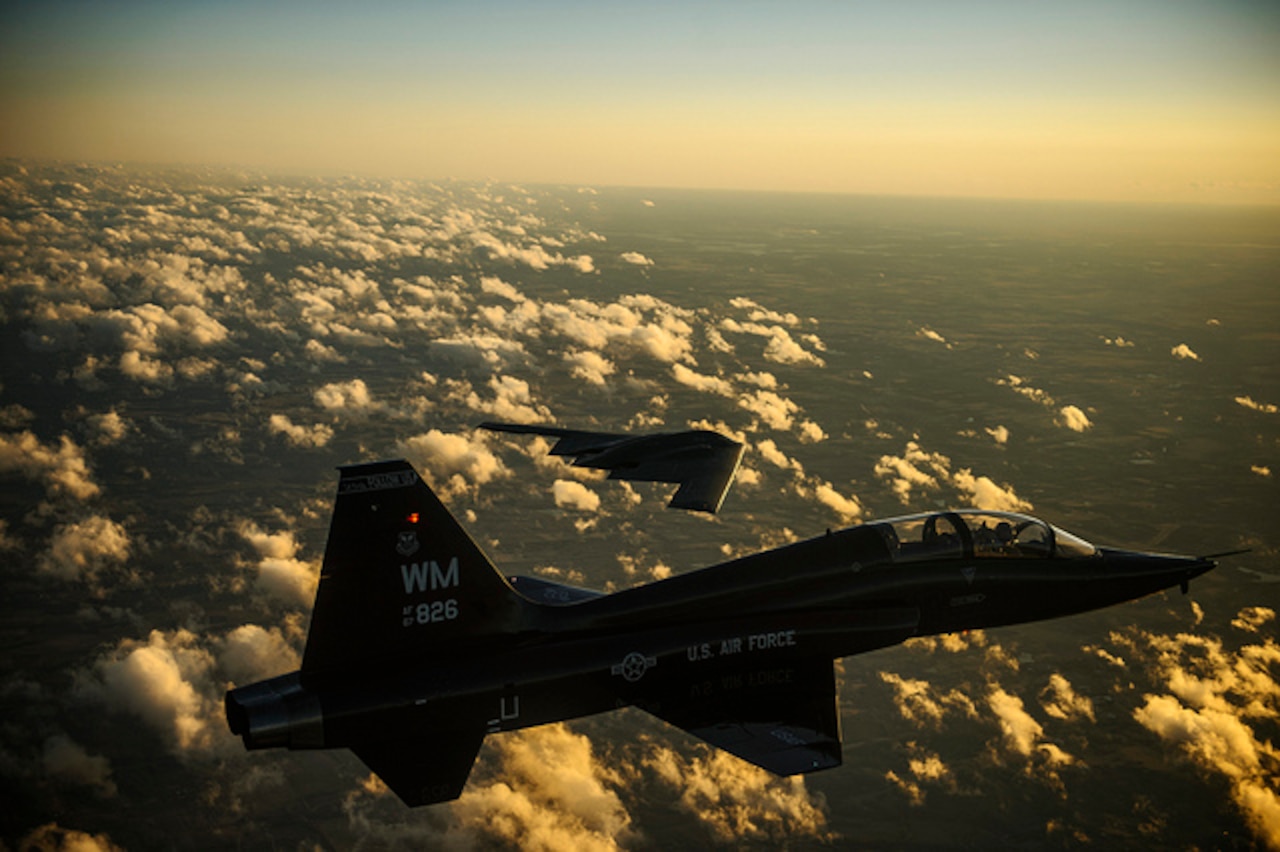 An Air Force T-38 Talon and B-2 Spirit fly in formation during a training mission over Whiteman Air Force Base, Mo., Feb. 20, 2014. The B-2 is a multirole bomber capable of delivering both conventional and nuclear ammunition. DoD photo by Air Force Staff Sgt. Jonathan Snyder