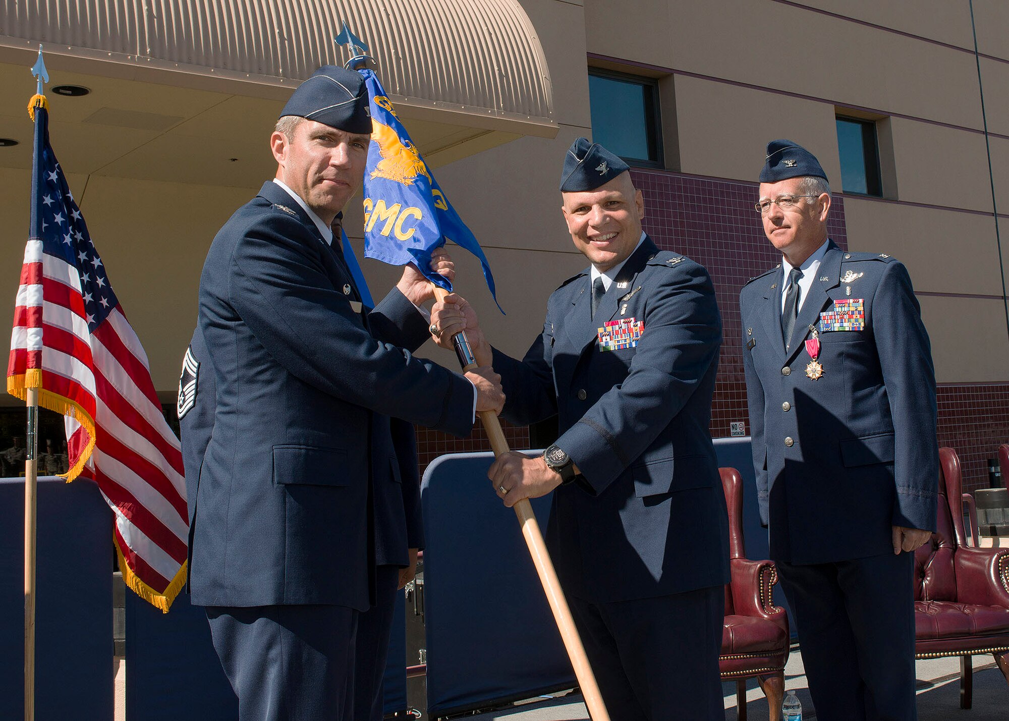 Col. (Dr.) Michael Higgins, 60th Medical Group commander, assumes command of the group during a change-of-command ceremony at Travis Air Force Base, Calif., July 8, 2016. (U.S. Air Force photo by T.C. Perkins Jr.)