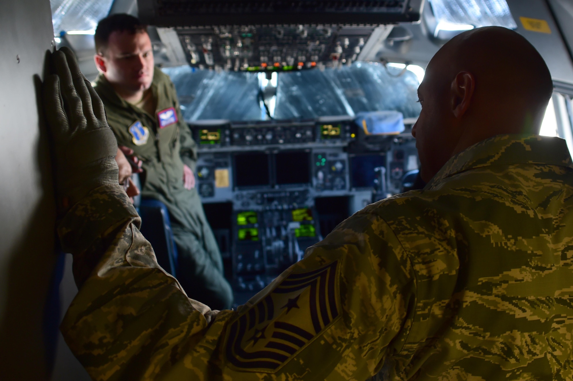 Chief Master Sgt. Rodney Lindsey, 460th Space Wing command chief, visits with the pilots of a C-17 Globemaster III from the Mississippi Air National Guard 183rd Airlift Wing July 12, 2016, on Buckley Air Force Base, Colo. The 183rd AW arrived to pick up and transport equipment and supplies needed by the 120th Fighter Squadron currently doing training operations in Papa, Hungary. (U.S. Air Force photo by Airman 1st Class Luke W. Nowakowski/Released)