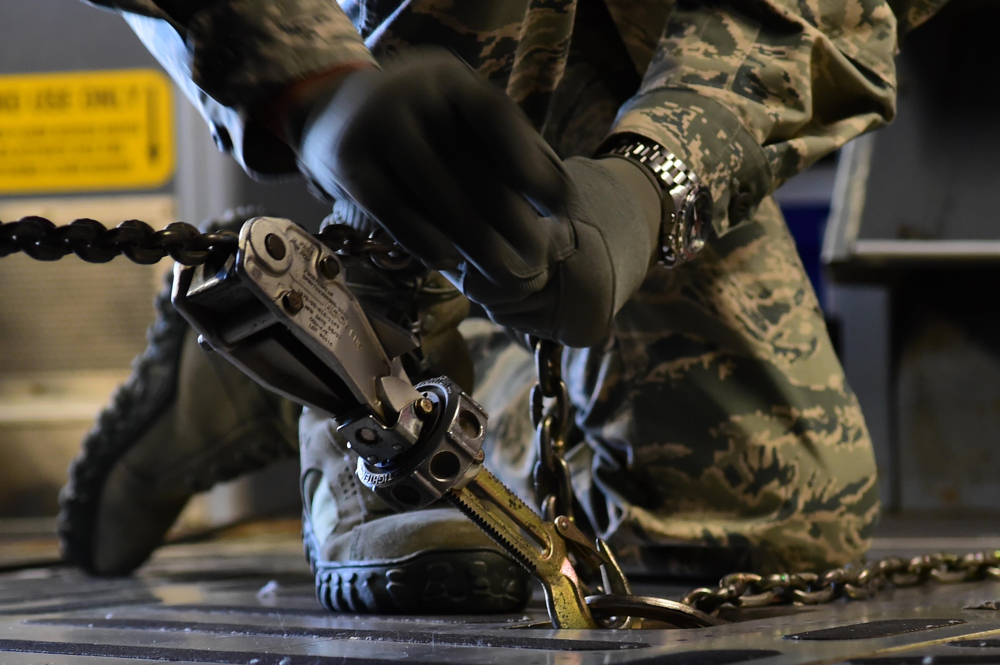 Chief Master Sgt. Rodney Lindsey, 460th Space Wing command chief, gets some hands on experience tightening down cargo July 12, 2016, on Buckley Air Force Base, Colo. Lindsey visited the flight line to find out how loadmasters organize and secure cargo. (U.S. Air Force photo by Airman 1st Class Luke W. Nowakowski/Released)