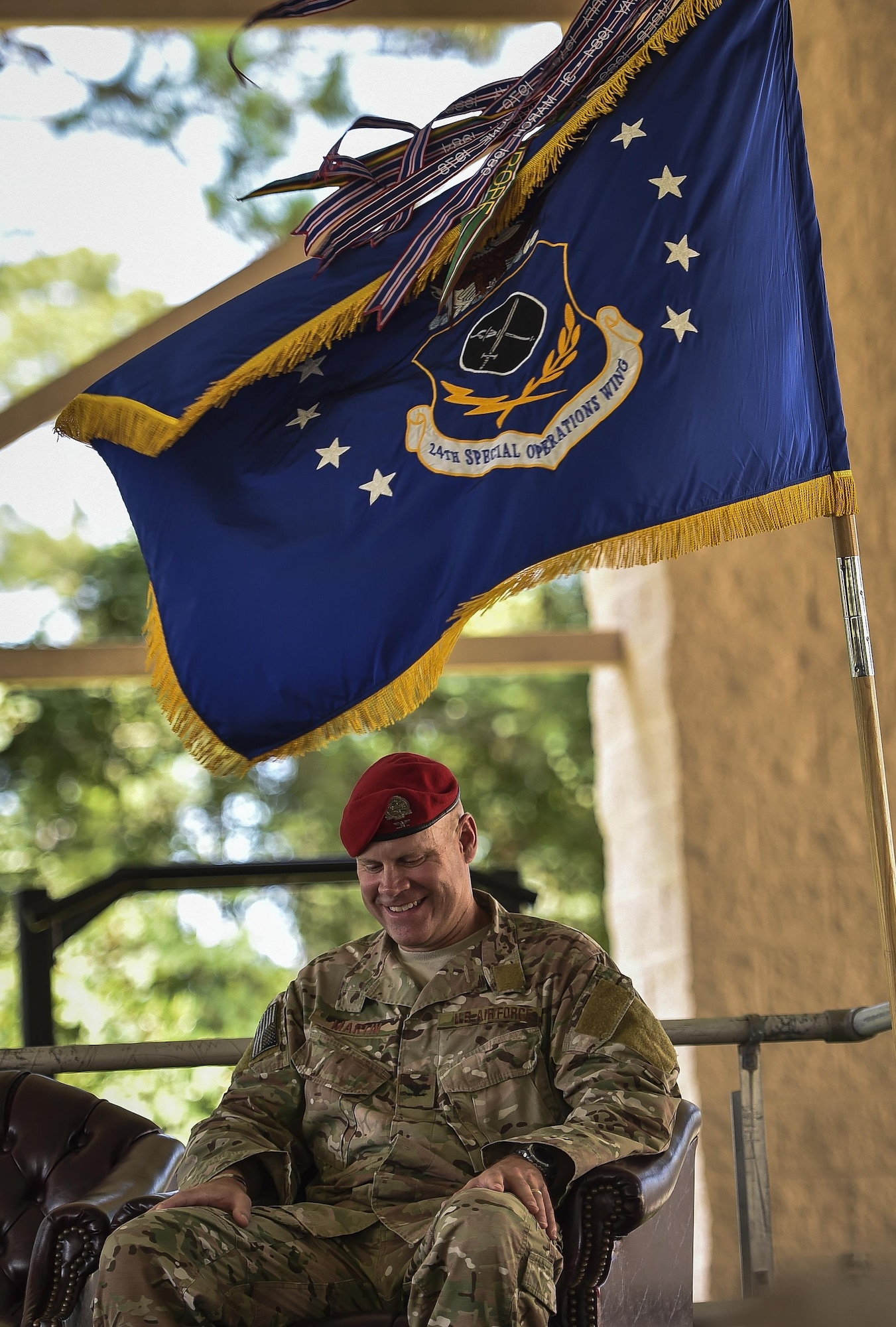 Col. Michael Martin, commander of the 24th Special Operations Wing, reacts to remarks made by Lt. Gen. Brad Heithold, commander of Air Force Special Operations Command, during the 24th SOW assumption of command at Hurlburt Field, Fla., July 14, 2016. Martin is the third Airman to take command of the 24th SOW since its activation in 2012. (U.S. Air Force photo by Senior Airman Ryan Conroy) 