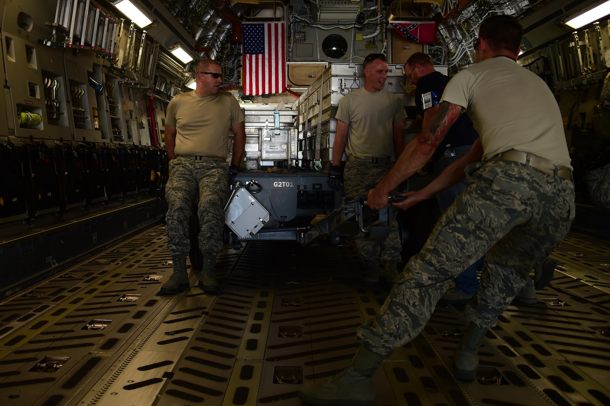 Airmen from the 140th Logistics Readiness Squadron load cargo onto a C-17 Globemaster III from the Mississippi Air National Guard 183rd Airlift Squadron July 12, 2016, on Buckley Air Force Base, Colo. The 183rd AS is transporting supplies and equipment to Papa, Hungary, that will be used to support the 120th Fighter Squadron, who is currently training with the Hungarian Air Force. (U.S. Air Force photo by Airman 1st Class Luke W. Nowakowski/Released)