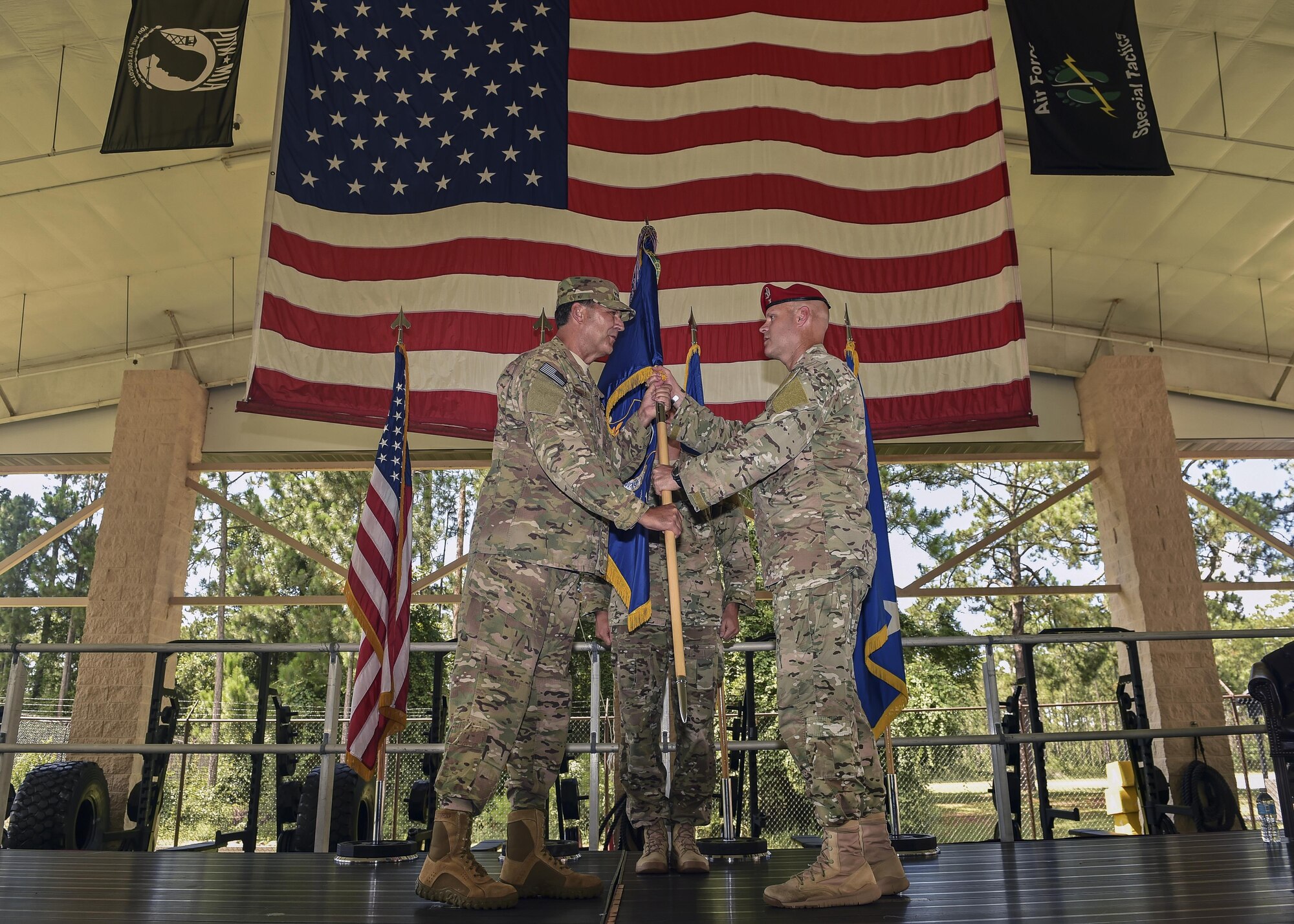 Lt. Gen. Brad Heithold, commander of Air Force Special Operations Command, presents the 24th Special Operations Wing guidon to Col. Michael Martin during the 24th SOW assumption of command at Hurlburt Field, Fla., July 14, 2016. The 24th SOW, previously commanded by Col. Matthew Davidson, boasts a unique ground operations mission set and approximately 1,500 of the 2,500 Special Tactics members in the Air Force. Martin previously served as the deputy commander of Special Operations Command-Africa in Stuttgart, Germany. (U.S. Air Force photo by Senior Airman Ryan Conroy) 