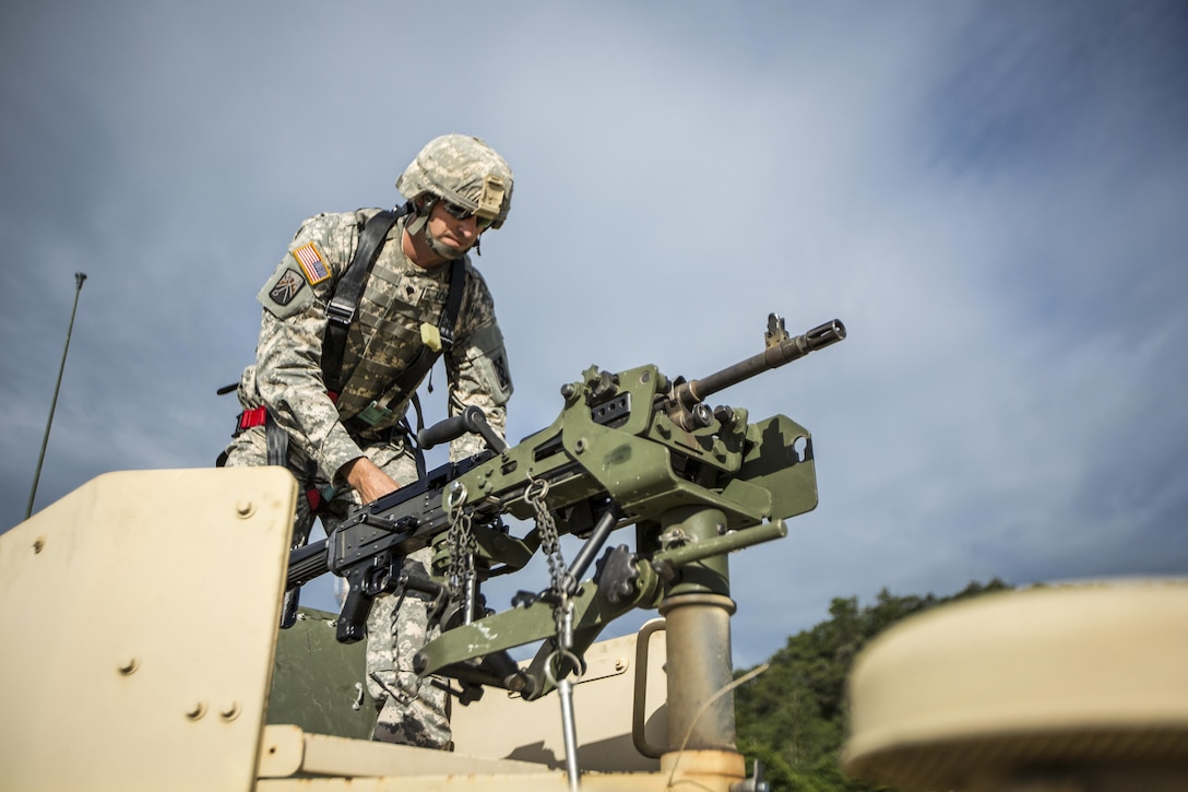 Army Spc. Keith Lowe prepares an M240B machine gun for a High Mobility Multipurpose Wheeled Vehicles live-fire exercise during Warrior Exercise 86-16-03 at Fort McCoy, Wis., July 13, 2016. The exercise aims to keep soldiers across the United States ready to deploy. Army photo by Spc. John Russell
