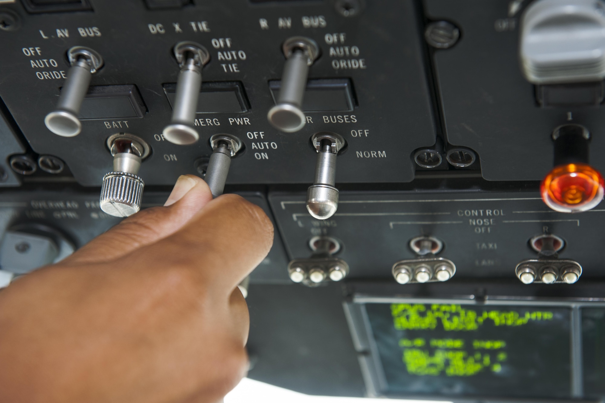 U.S. Air Force Staff Sgt. Arsonio Arthur, 733rd Air Mobility Squadron instrument flight controls systems craftsman, checks an emergency power switch on a C-17 Globemaster July 6, 2016, at Kadena Air Base, Japan. As cargo was loaded onto the C-17, power needed to be distributed throughout the aircraft to keep the cargo cool amidst the heat. (U.S. Air Force photo by Airman 1st Class Lynette M. Rolen)