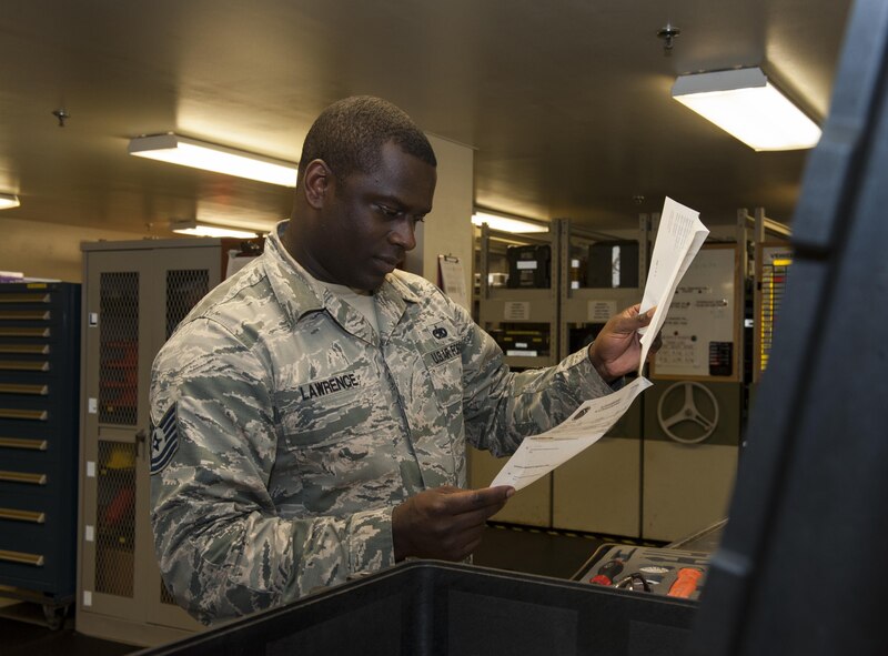 U.S. Air Force Tech. Sgt. Steven Lawrence, 733rd Air Mobility Squadron quality assurance office chief inspector, checks a maintenance tool kit during a QA inspection July 6, 2016, at Kadena Air Base, Japan. The paperwork used to check the tool kit contains a checklist which the inspector utilizes throughout the inspection process. (U.S. Air Force photo by Airman 1st Class Lynette M. Rolen)
