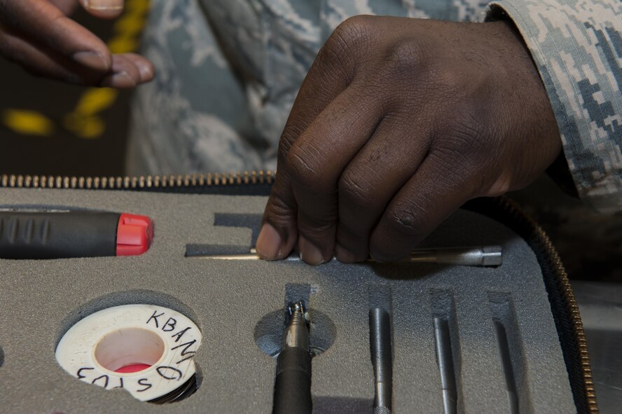 U.S. Air Force Tech. Sgt. Steven Lawrence, 733rd Air Mobility Squadron quality assurance office chief inspector, examines tools during a QA inspection July 6, 2016, at Kadena Air Base, Japan. This particular set of tools is used for emergencies and occasional routine maintenance. (U.S. Air Force photo by Airman 1st Class Lynette M. Rolen)