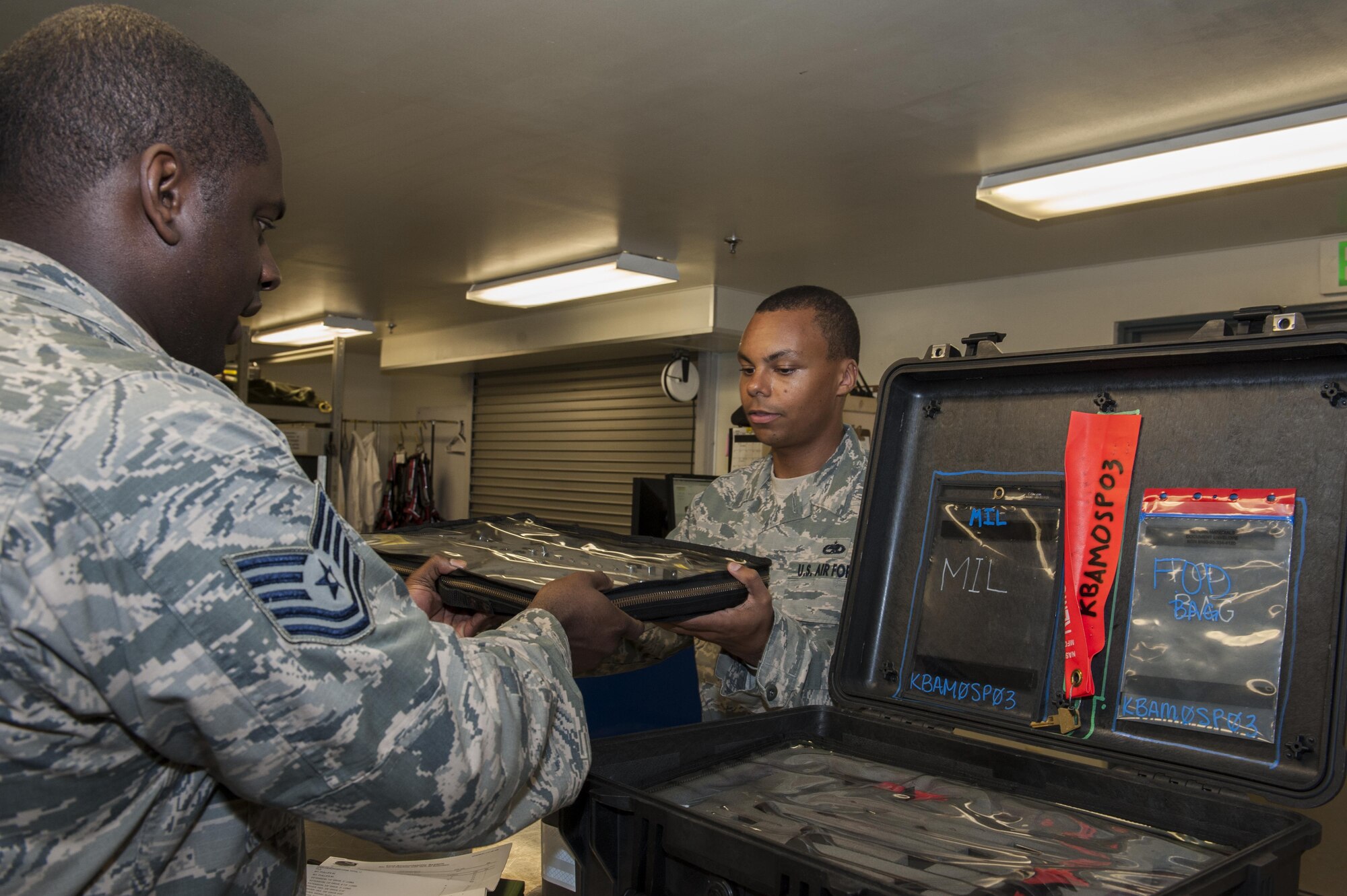 U.S. Air Force Tech. Sgt. Steven Lawrence, 733rd Air Mobility Squadron quality assurance office chief inspector, provides an inspection out-brief to Staff Sgt. Andrew Boucher, 733rd AMS support section assistant NCO in charge July 6, 2016, at Kadena Air Base, Japan. The purpose of the inspection out-brief is relaying the results of the inspection and suggesting any changes which need to be made. (U.S. Air Force photo by Airman 1st Class Lynette M. Rolen)