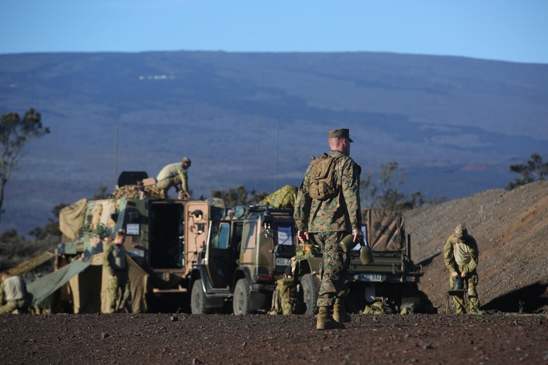 160713-M-UK649-006 POHAKULOA TRAINING AREA, Hawaii (July 13, 2016) – A U.S. Marine, attached to 2nd Battalion, Royal  Australian Regiment during Rim of the Pacific 2016, prepares for the heat by packing two canteens and strapping on a hydration pack prior to a live fire range at Pohakuloa Training Area, Hawaii, July 13, 2016. Twenty-six nations, 49 ships, six submarines, about 200 aircraft, and 25,000 personnel are participating in RIMPAC 16 from June 29 to Aug. 4 in and around the Hawaiian Islands and Southern California. The world’s largest international maritime exercise, RIMPAC provides a unique training opportunity while fostering and sustaining cooperative relationships between participants critical to ensuring the safety of sea lanes and security on the world’s oceans.  The pictured Marine is with 2nd Battalion, 3rd Marine Regiment, an infantry unit that supports III Marine Expeditionary Force. (U.S. Marine Corps Photo by Staff Sgt. Jesse R. Stence)