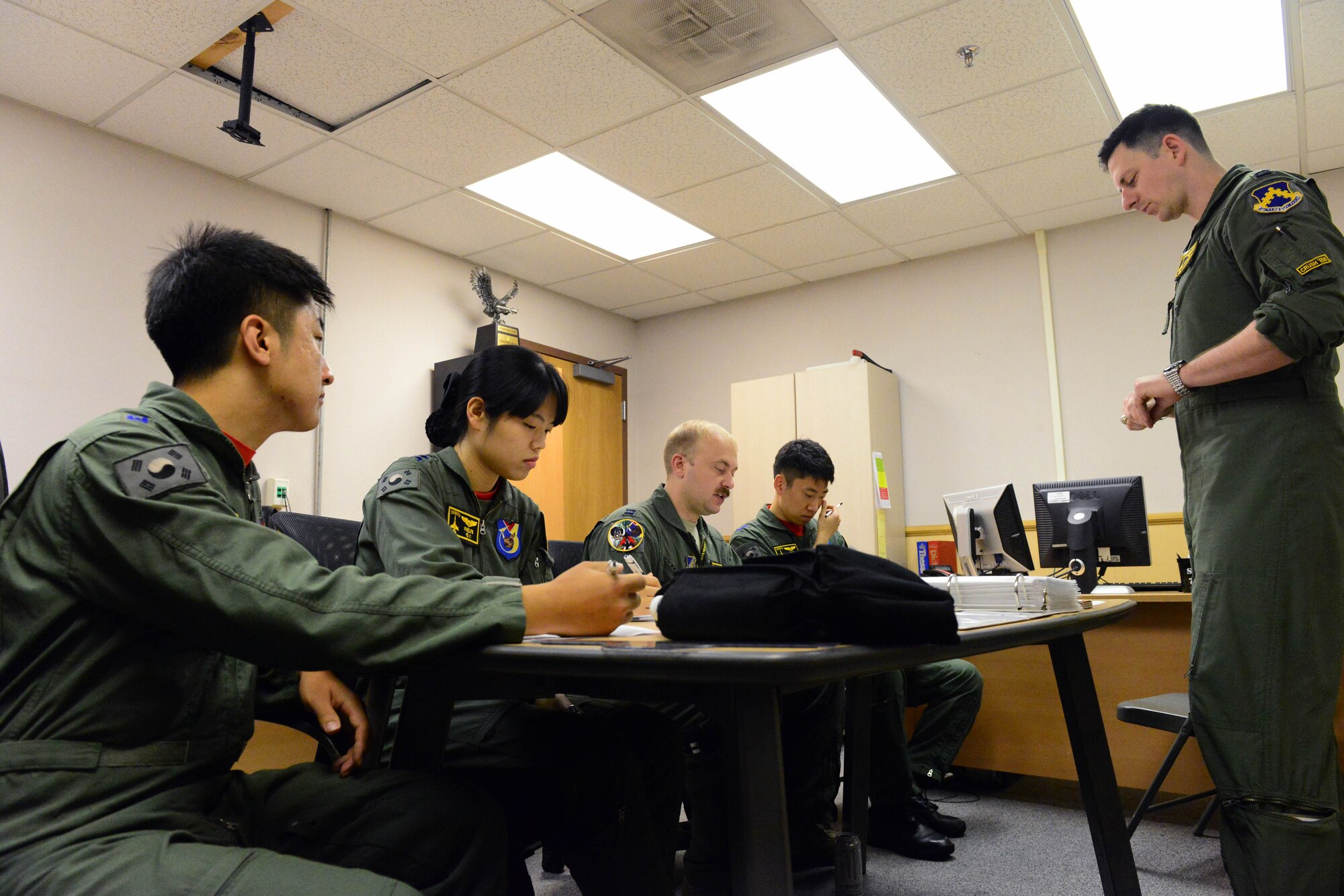 U.S. Air Force and ROKAF pilots participate in a pre-brief before soaring the skies in preparation for Buddy Wing 16-6 July 14, 2016 at Kunsan Air Base, Republic of Korea. Buddy Wing exercises are conducted at various ROKAF and U.S. Air Force bases multiple times throughout the year on the Korean peninsula. The combined fighter exchange program provides pilots an opportunity to exchange ideas and practice combined tactics in order to fight and fly as one Allied force. (U.S. Air Force photo by Senior Airman Ashley L. Gardner/ Released)