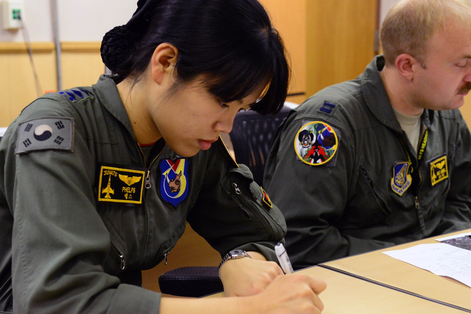 U.S. Air Force and ROKAF pilots participate in a pre-brief before soaring the skies in preparation for Buddy Wing 16-6 July 14, 2016 at Kunsan Air Base, Republic of Korea. Buddy Wing exercises are conducted at various ROKAF and U.S. Air Force bases. In the combined fighter exchange program the pilots have an opportunity to exchange ideas and practice combined tactics to fight and fly as one Allied force. (U.S. Air Force photo by Senior Airman Ashley L. Gardner/ Released)