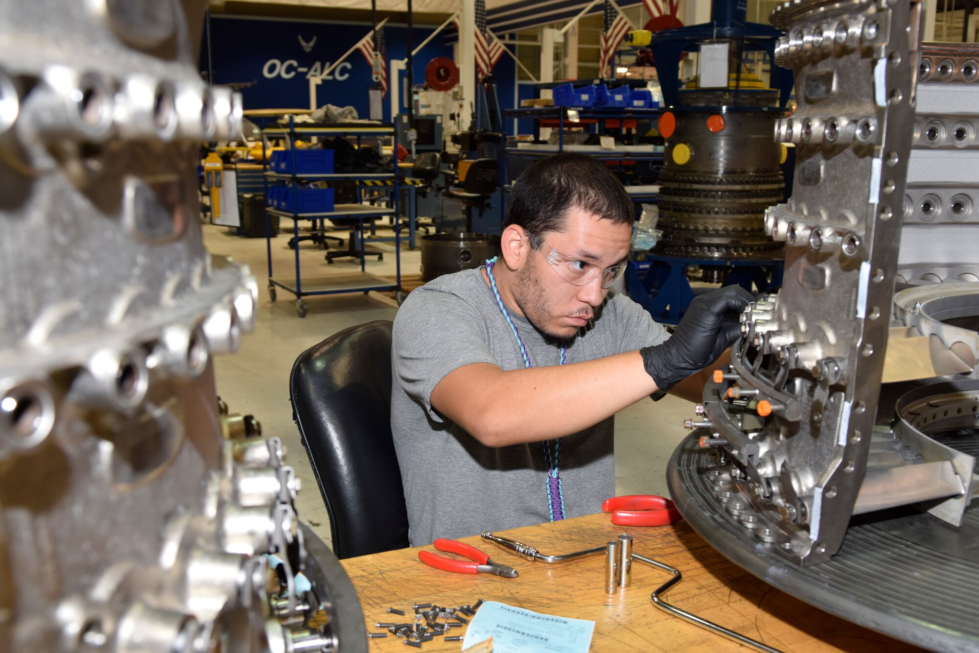 Samuel Cervantes, Oklahoma City Air Logistics Complex jet engine mechanic, installs compressor vanes on a split-case of a F117 engine used on C-17A Globemaster III aircraft at his work station June 13, 2016, Tinker Air Force Base, Okla. Cervantes follows precise steps during assembly to deliver the completed component without defects and ready for use. (U.S. Air Force photo/Greg L. Davis)