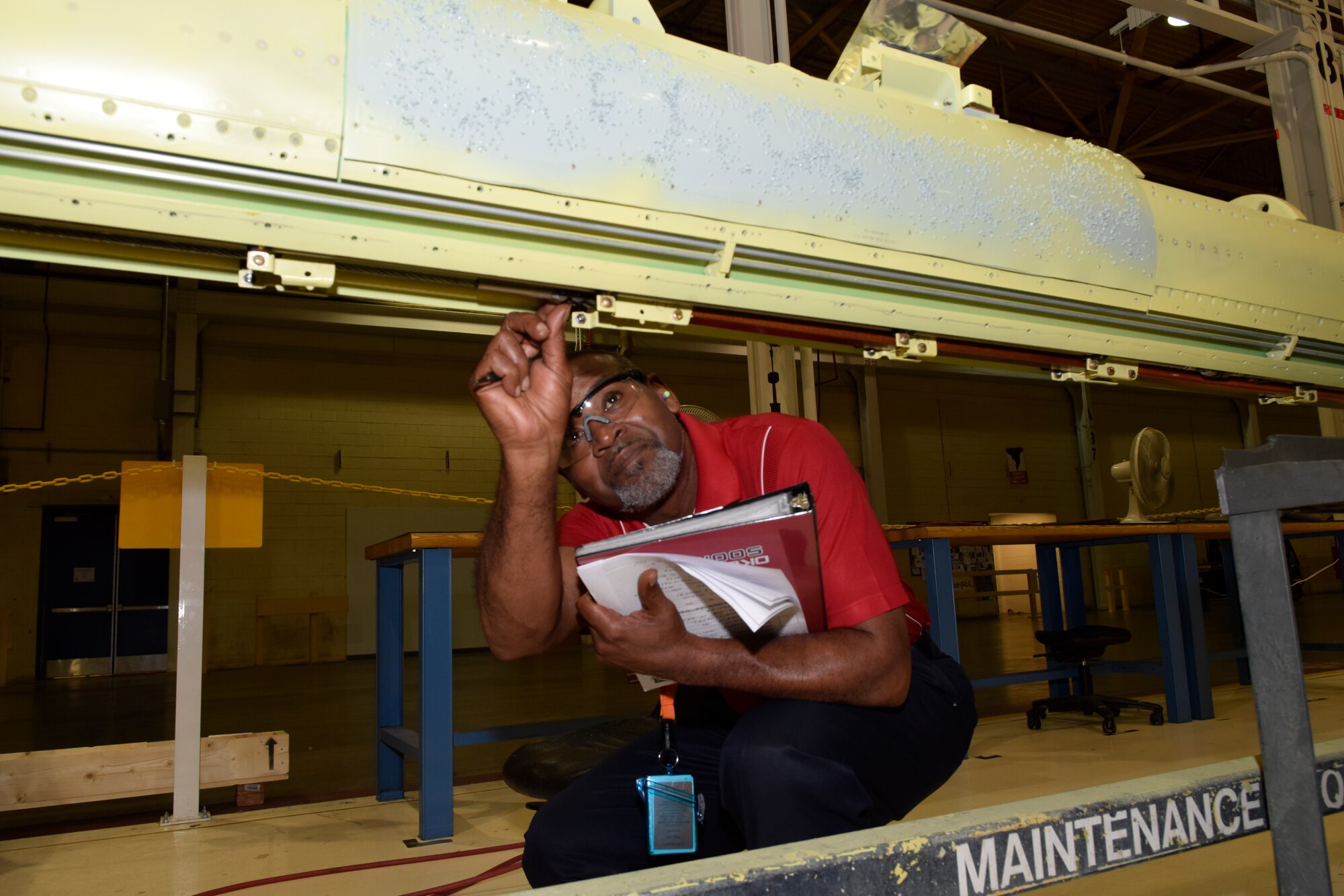 Charles Jackson, Oklahoma City Air Logistics Complex quality assurance inspector in the commodities division, performs a final visual inspection of critical components just installed by OC-ALC mechanics on a KC-135 aerial refueling boom June 13, 2016, Tinker Air Force Base, Okla. Jackson watched the entire process to ensure the right parts were used, assembled in the correct order and function as specified by his technical data sheets shown in his hand. (U.S. Air Force photo/Greg L. Davis)