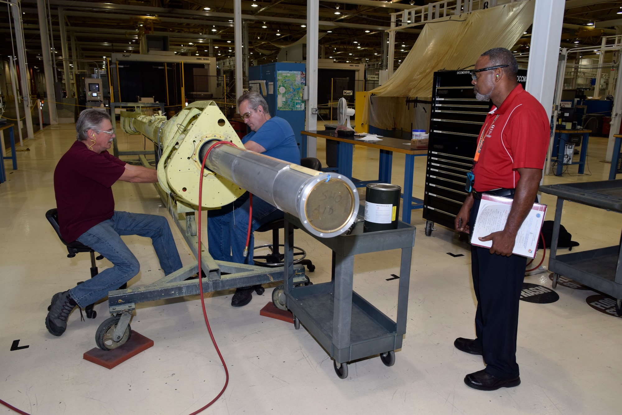 Charles Jackson, right, Oklahoma City Air Logistics Complex quality assurance inspector in the commodities division, observes two mechanics as they install components on a KC-135 aerial refueling boom June 13, 2016, Tinker Air Force Base, Okla. Jackson is watching the process to potentially catch any problems with the complex instillation. (U.S. Air Force photo/Greg L. Davis)