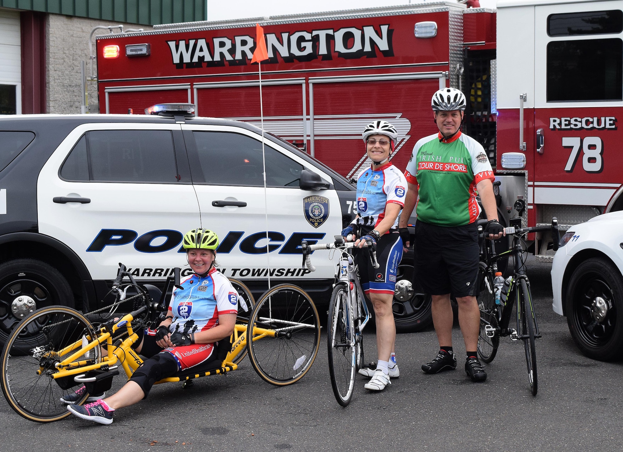 Members of the Horsham Air Guard Station team with local police chief for a 15 mile test run of cycling routes to prepare bicyclists for upcoming larger events. Stopping at the Warrington Township Fire Company Number 1 along Easton Road, Theresa Arentzen, program support technician with the Employers Support of the Guard and Reserve, left, Lt. Col. Claudia Malone, 112th Cyberspace Operations Squadron commander and Horsham Chief of Police, Bill Daly are greeted by first responders from Warrington and Horsham, Pennsylvania on July 14, 2016.  (U.S. Air National Guard photo by Master Sgt. Christopher Botzum)