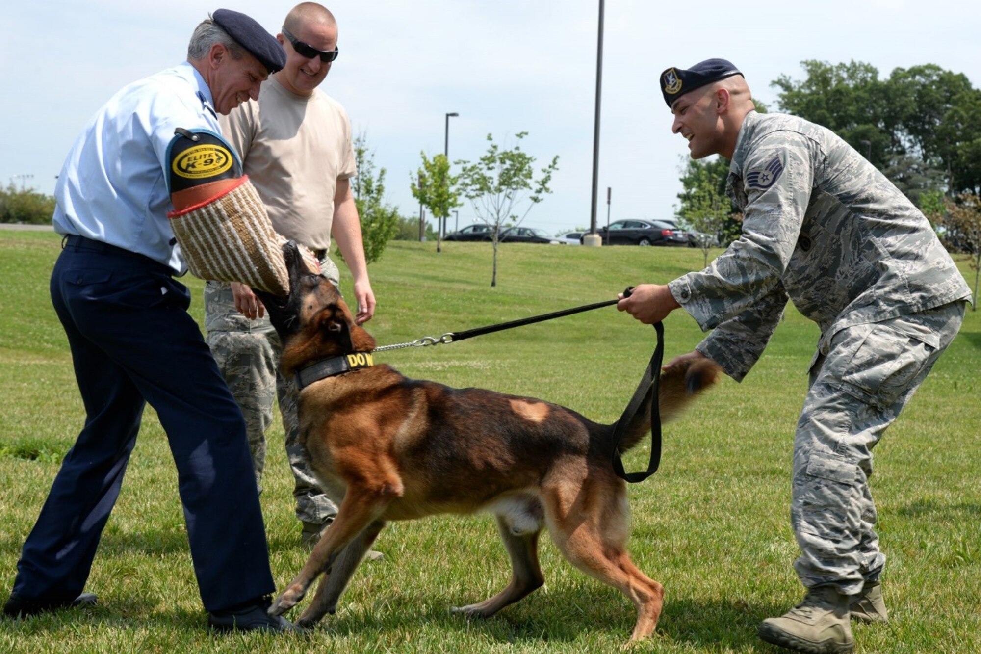 11th Security Support Squadron military working dog handler Staff Sgt. Christopher Pettis, Tech Sgt. Joseph Hall, and MWD Gip demonstrate K-9 capabilities with Senior Enlisted Leader International Summit (SELIS) attendee Belgium Air Force Adjutant Chief Erik Bejstrup on Joint Base Andrews, Md., July 13, 2016. The SELIS is a forum of international senior enlisted leaders hosted by Chief Master Sergeant of the Air Force James A. Cody. (U.S. Air Force photo/ Tech. Sgt. Matt Davis)
