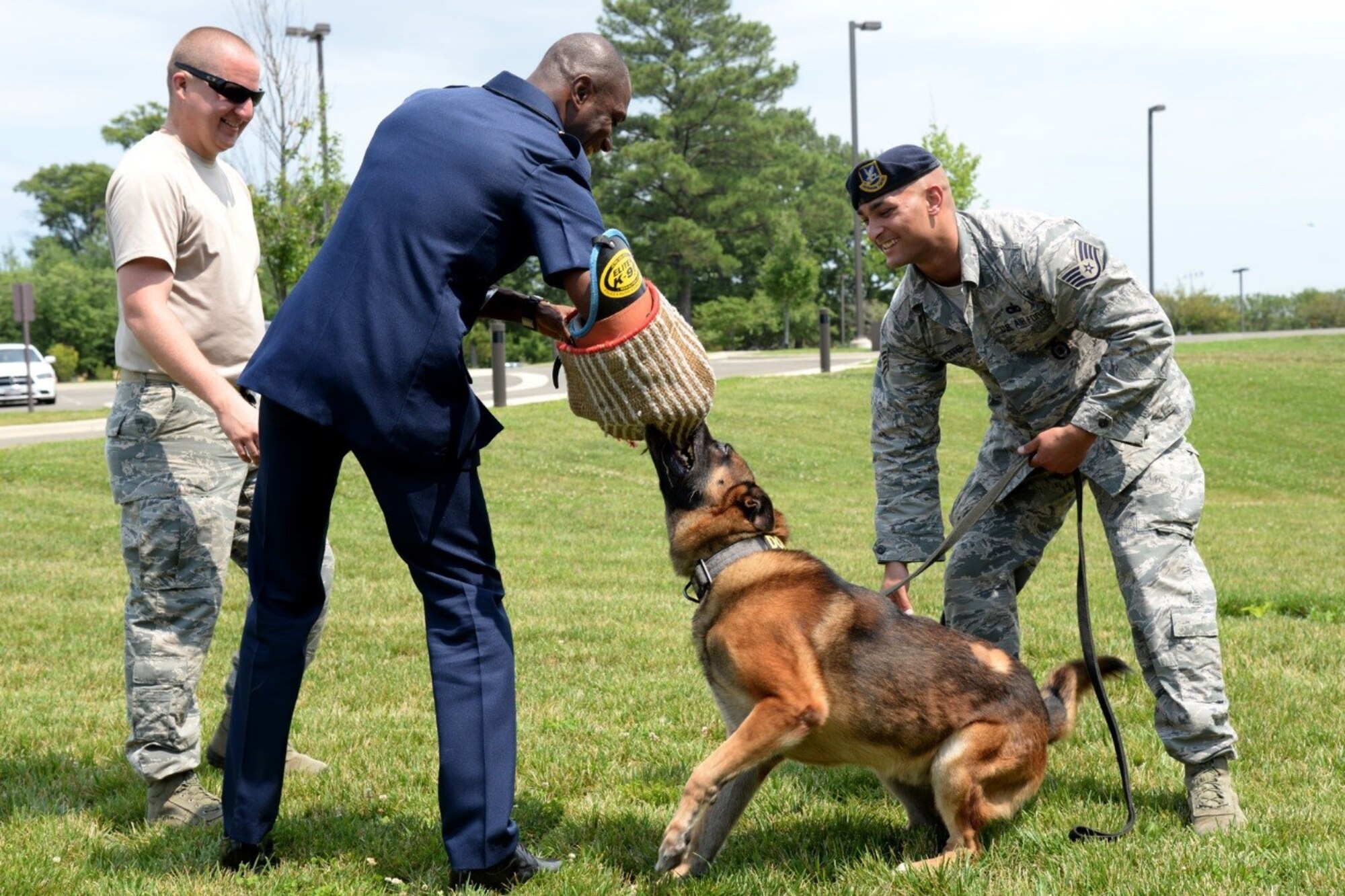 11th Security Support Squadron military working dog handler Staff Sgt. Christopher Pettis, Tech Sgt. Joseph Hall, and MWD Gip with Senior Enlisted Leader International Summit (SELIS) attendee Ghana Air Force Warrant Officer Class 1 Jacob Kwafo-Asare on Joint Base Andrews, Md., July 13, 2016. The SELIS is a forum of international senior enlisted leaders hosted by Chief Master Sergeant of the Air Force James A. Cody. (U.S. Air Force photo/ Tech. Sgt. Matt Davis)