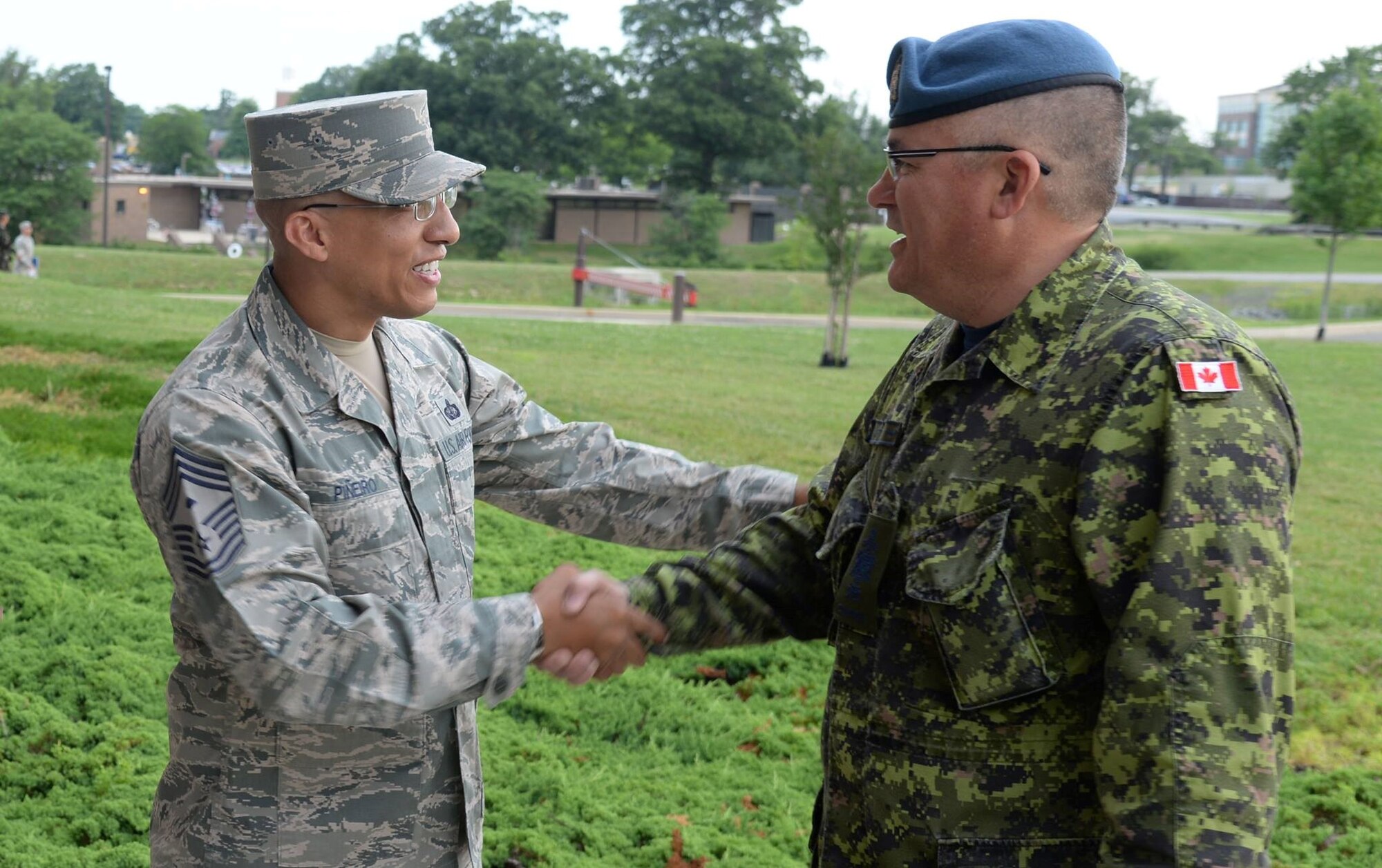 Air Force District of Washington First Sergeant Chief Master Sgt. Manny Pineiro greets Canadian Air Force Chief Warrant Officer Pierrot Jetté as he arrives at the Senior Enlisted Leader International Summit (SELIS) on Joint Base Andrews, Md., July 13, 2016. The SELIS is a forum of international senior enlisted leaders hosted by Chief Master Sergeant of the Air Force James A. Cody. (U.S. Air Force photo/ Tech. Sgt. Matt Davis)