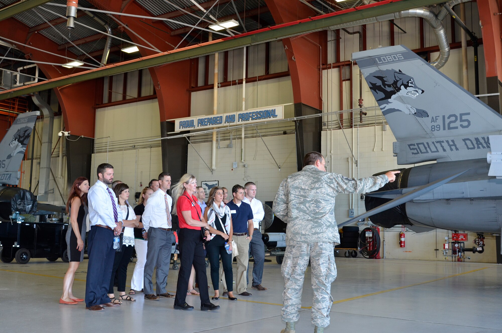 SIOUX FALLS, S.D. - Master Sgt. Chris Portice, 114th Maintenance Squadron avionics technician, explains to members of the Sioux Falls Area Chamber of Commerce Young Professionals Network what his position at the South Dakota Air National Guard includes during a tour given at Joe Foss Field, S.D. on July 13, 2016.(U.S. Air National Guard photo by Maj. Travis Schuring/released)