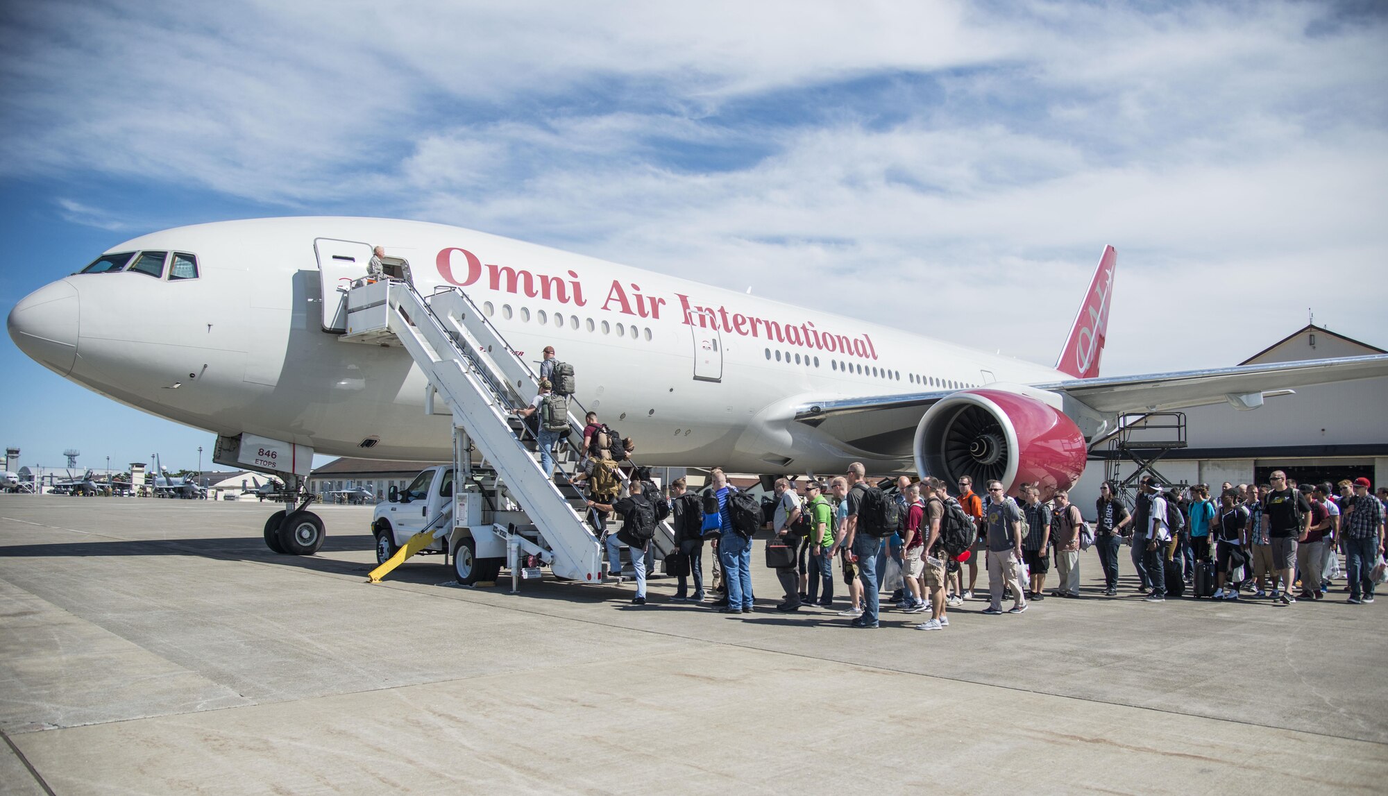 U.S. Air Force Airmen board a Boeing 757 at Misawa Air Base, Japan, July 11, 2016. The plane was destined for Pangkalan Udara Butterworth and Pangkalan Udara Subang, Malaysia, where nearly 250 Airmen from the 35th Fighter Wing will participate in exercise Cope Taufan 16. The exercise allows for an exchange of techniques and procedures to enhance interoperability and cooperation between U.S. and Royal Malaysian Airmen. (U.S. Air Force photo by Senior Airman Brittany A. Chase)